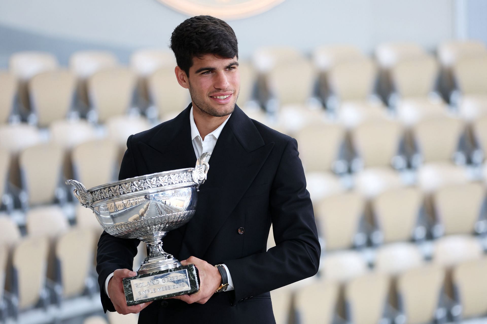 Carlos Alcaraz poses with the trophy at the 2024 Mens French Open Winner Photocall