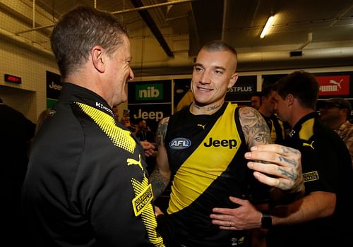 Dustin Martin of the Tigers celebrates after his 200th game with head coach Damien Hardwick