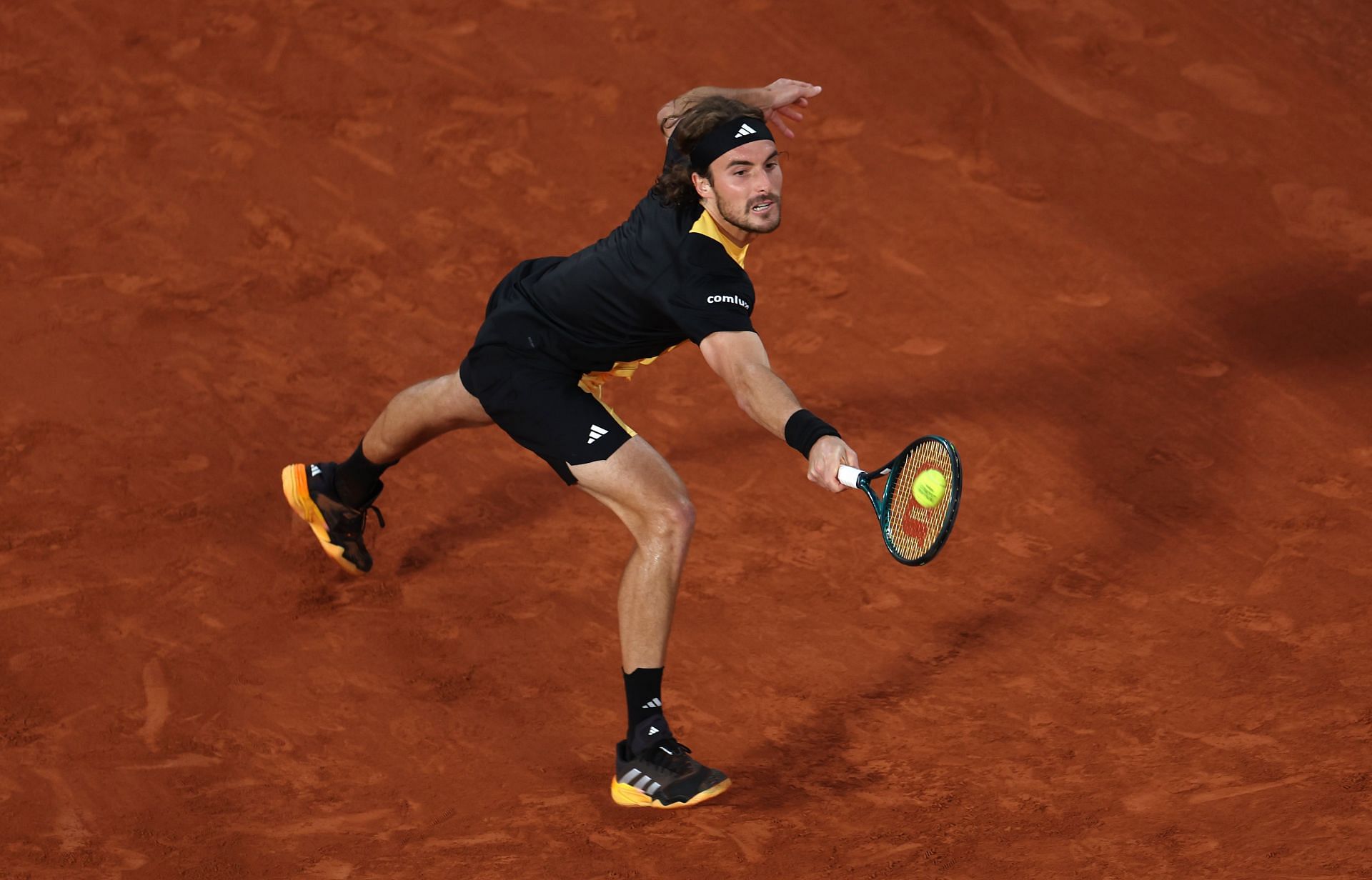 Stefanos Tsitsipas retrieves a ball at French Open 2024