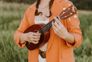 A woman playing the ukulele (Photo via Pexels/ juliane sanchez)
