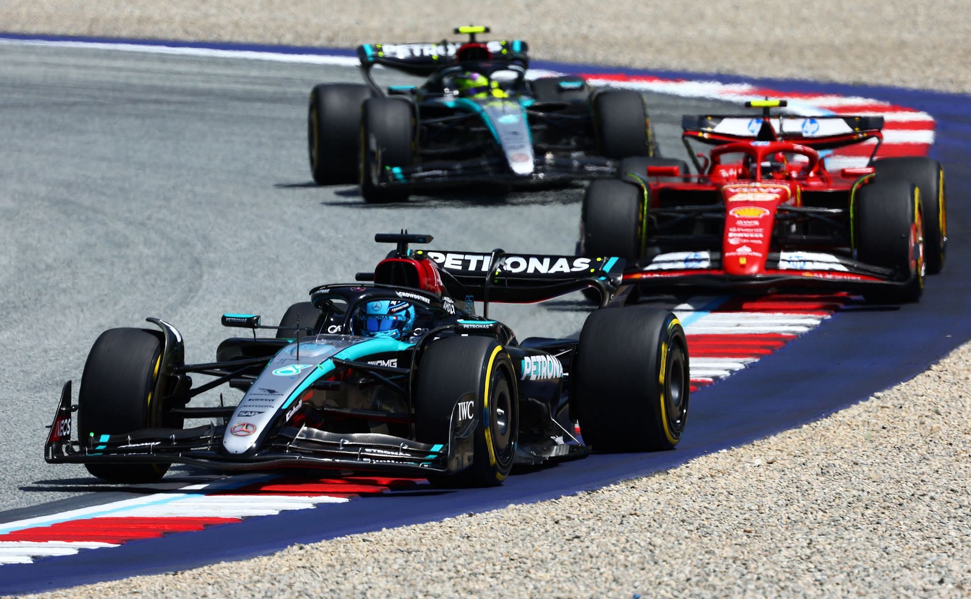 George Russell of Great Britain driving the (63) Mercedes AMG Petronas F1 Team W15 leads Carlos Sainz of Spain driving (55) the Ferrari SF-24 during the Sprint ahead of the F1 Grand Prix of Austria at Red Bull Ring on June 29, 2024 in Spielberg, Austria. (Photo by Clive Rose/Getty Images)