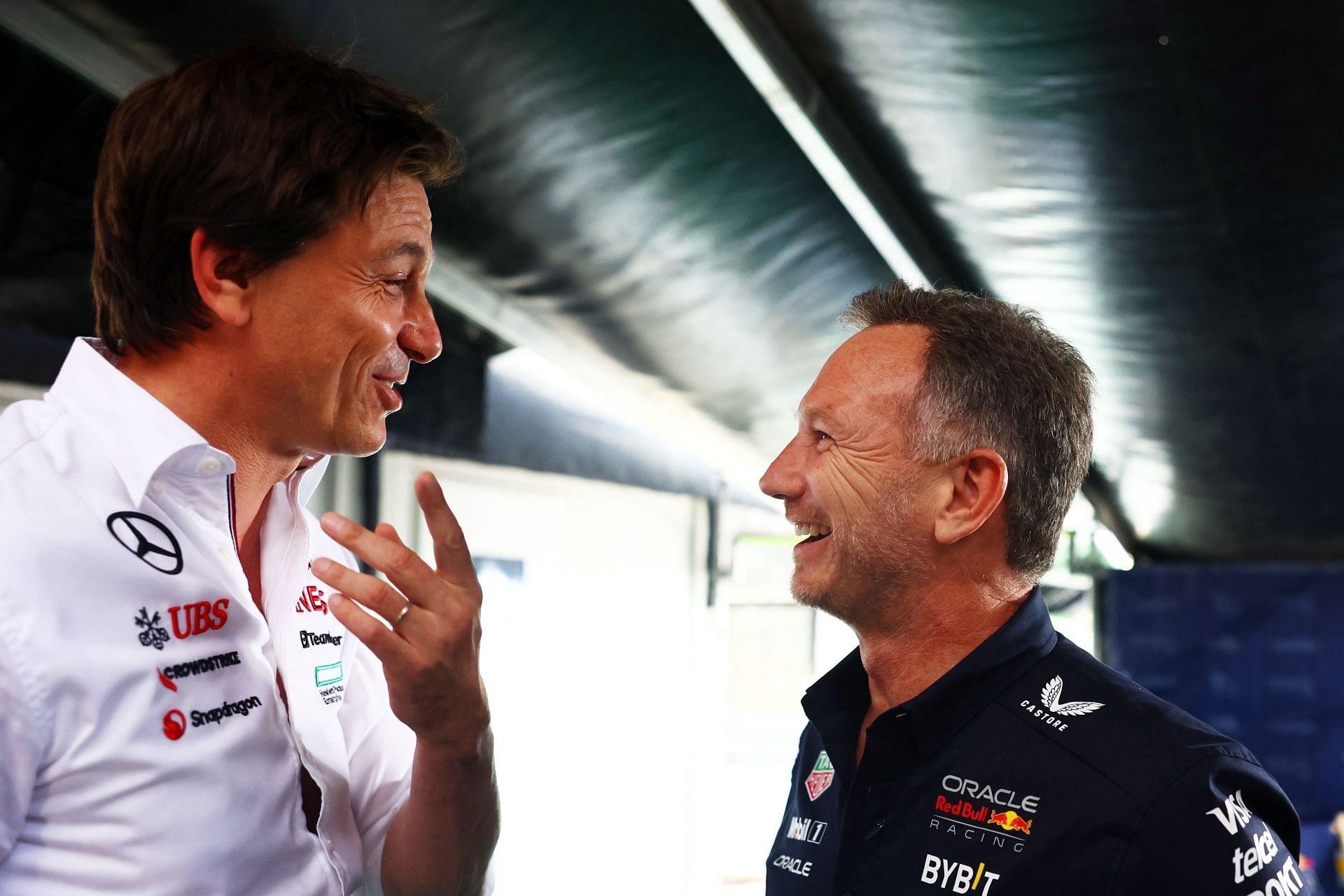 Oracle Red Bull Racing Team Principal Christian Horner talks with Mercedes GP Executive Director Toto Wolff in the Paddock. Courtesy: Getty Images