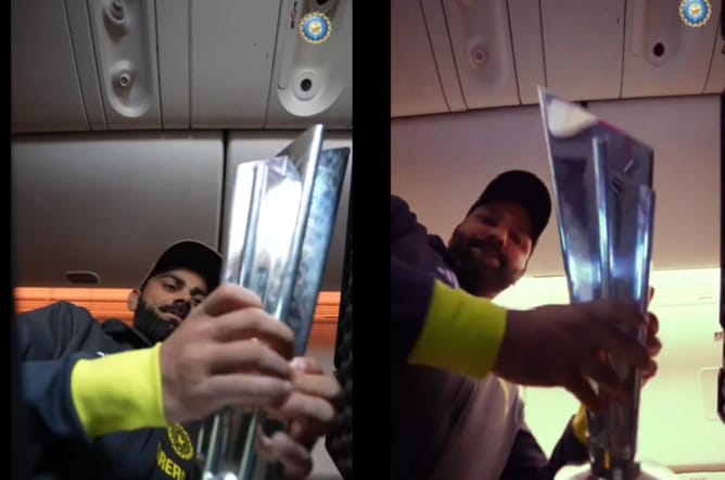 [Watch] "It's home" - BCCI shares video of players taking out and relishing T20 World Cup Trophy inside flight