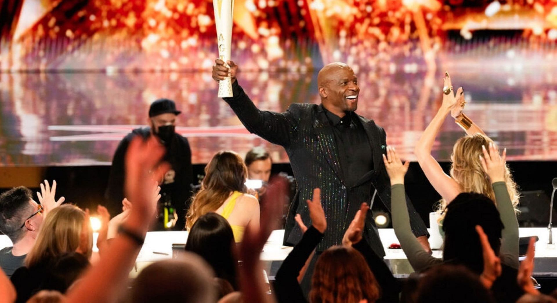 Terry Crews carries the Olympic Torch during America