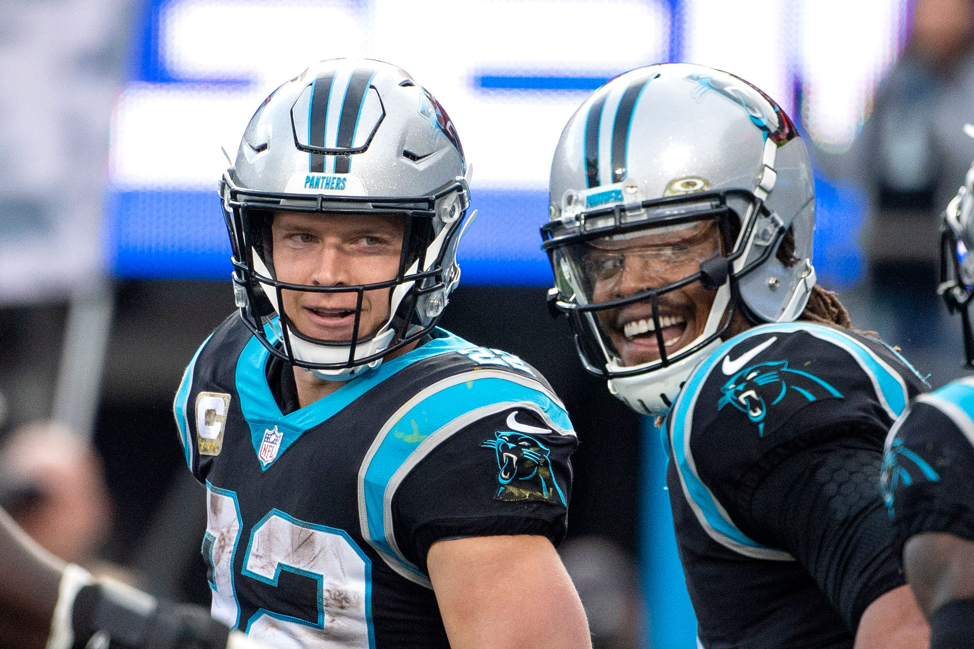 Cam Newton with Christian McCaffrey (Imagn)