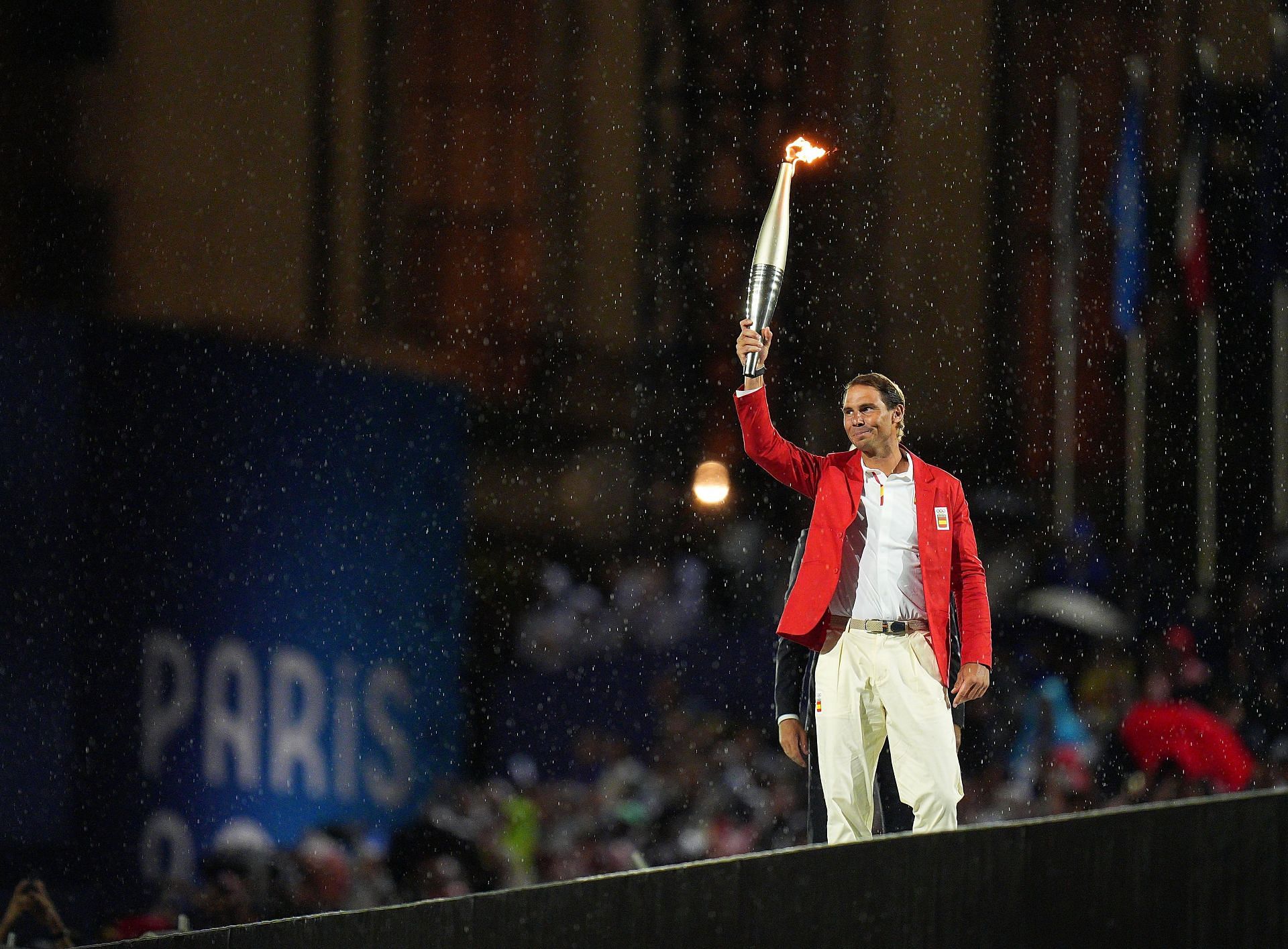 Rafael Nadal holds the Olympic torch during the Olympics Opening Ceremony (Image via Getty).