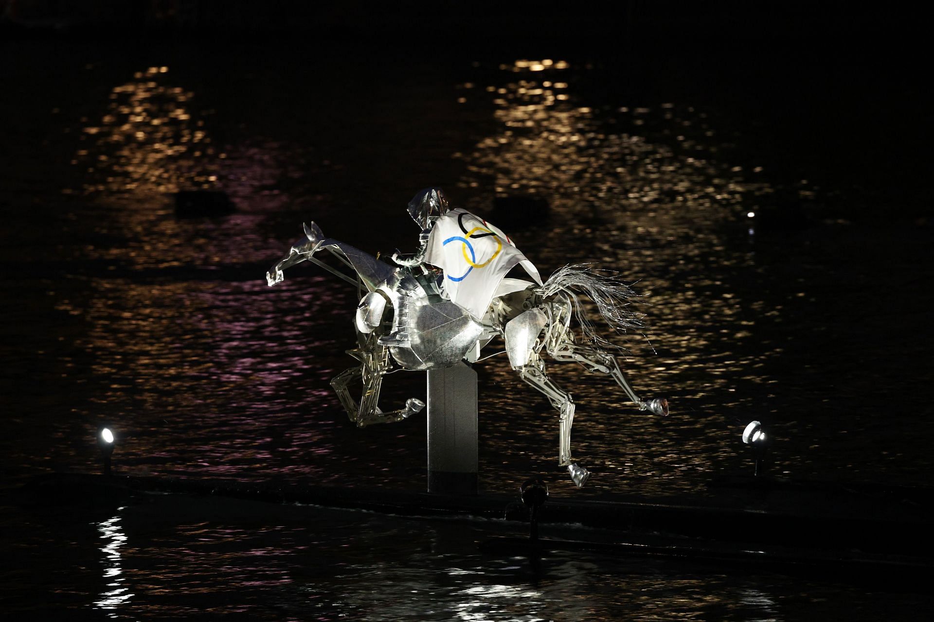 A performer rides on a metal horse up the river Seine during the Opening Ceremony - Olympic Games Paris 2024: Day 0 - Source: Getty