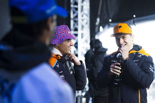 Lando Norris of Great Britain and McLaren and Oscar Piastri of Australia and McLaren look on from the fan stage prior to practice ahead of the F1 Grand Prix of Great Britain at Silverstone Circuit on July 05, 2024 in Northampton, England. (Photo by Rudy Carezzevoli/Getty Images)