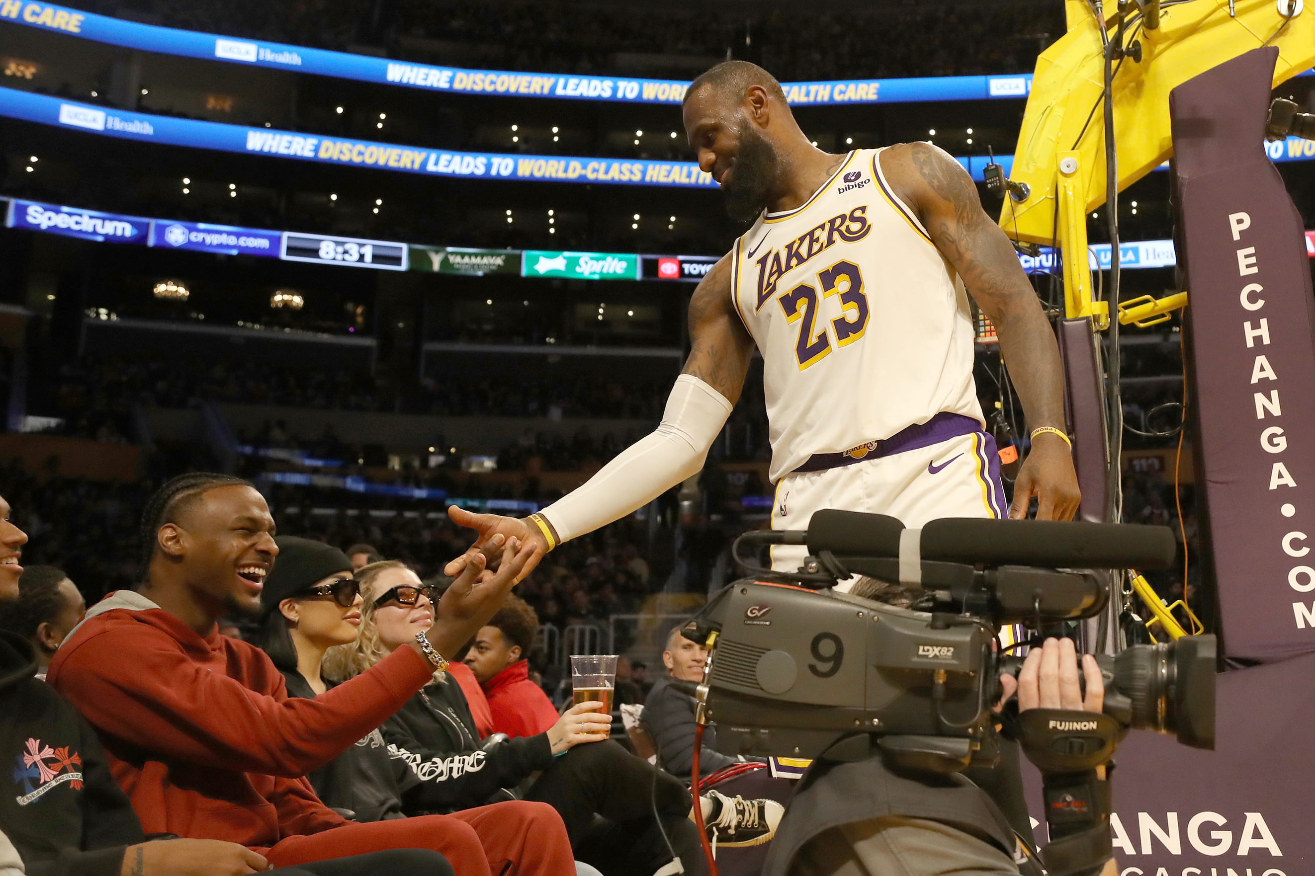 LeBron James shakes hands with his son Bronny James during a game against the Houston Rockets (Photo Credit: IMAGN)