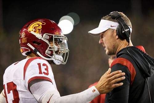 Former USC quarterback Caleb Williams talks with Trojans coach Lincoln Riley.