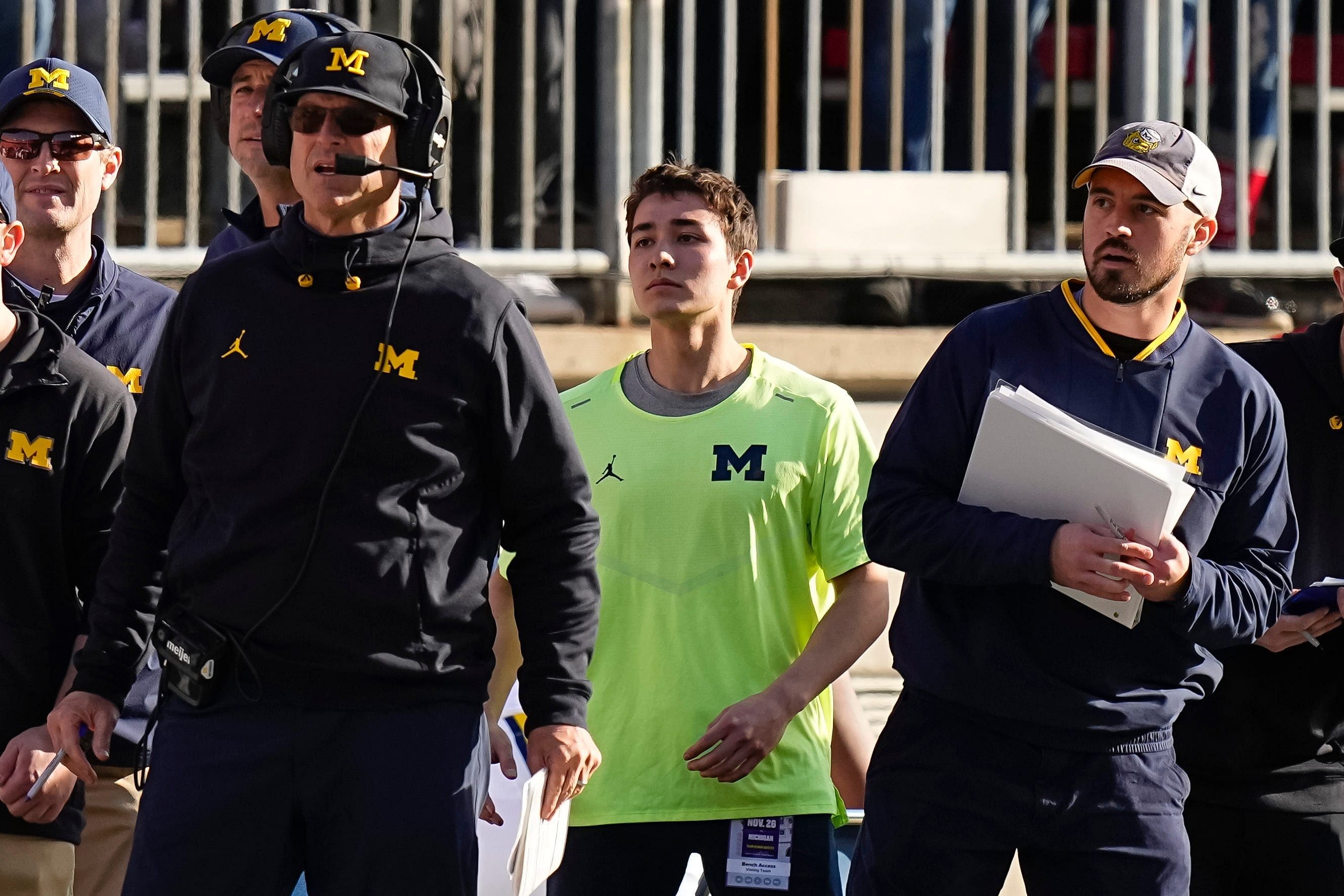 Michigan Wolverines head coach Jim Harbaugh watches from the sideline beside off-field analyst Connor Stalions, right. (Image credit: IMAGN)