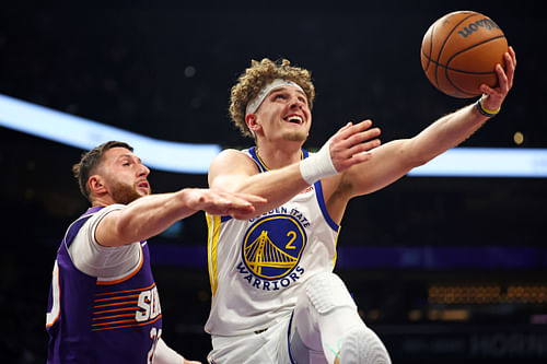 Golden State Warriors guard Brandin Podziemski shoots the ball against Phoenix Suns center Jusuf Nurkic Photo Credit: Mark J. Rebilas-USA TODAY Sports/Imagn