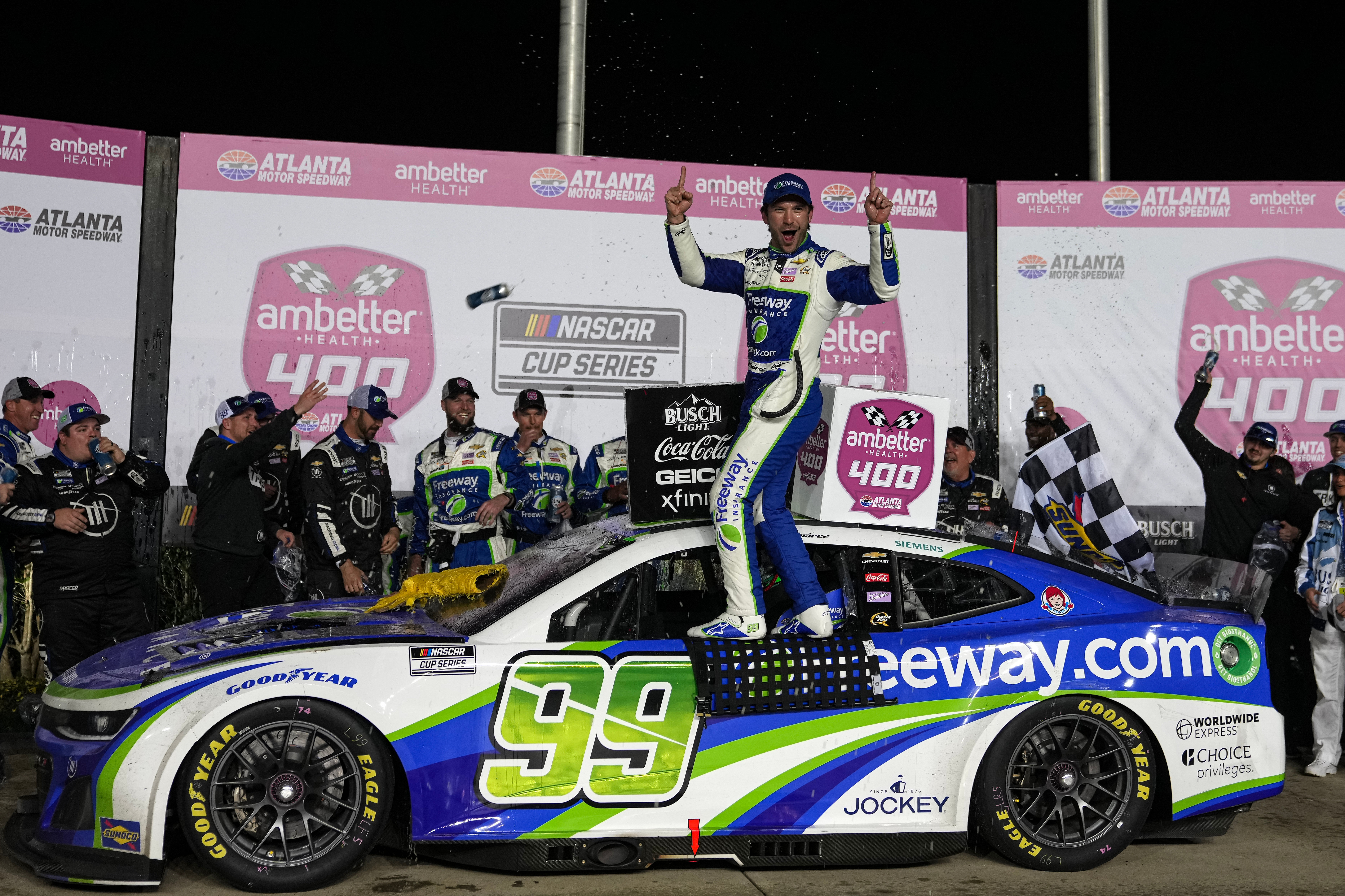 Feb 25, 2024; Hampton, Georgia, USA; NASCAR Cup Series driver Daniel Suarez (99) celebrates in Victory Lane after winning the Ambetter Health 400 at Atlanta Motor Speedway. Mandatory Credit: David Yeazell-USA TODAY Sports