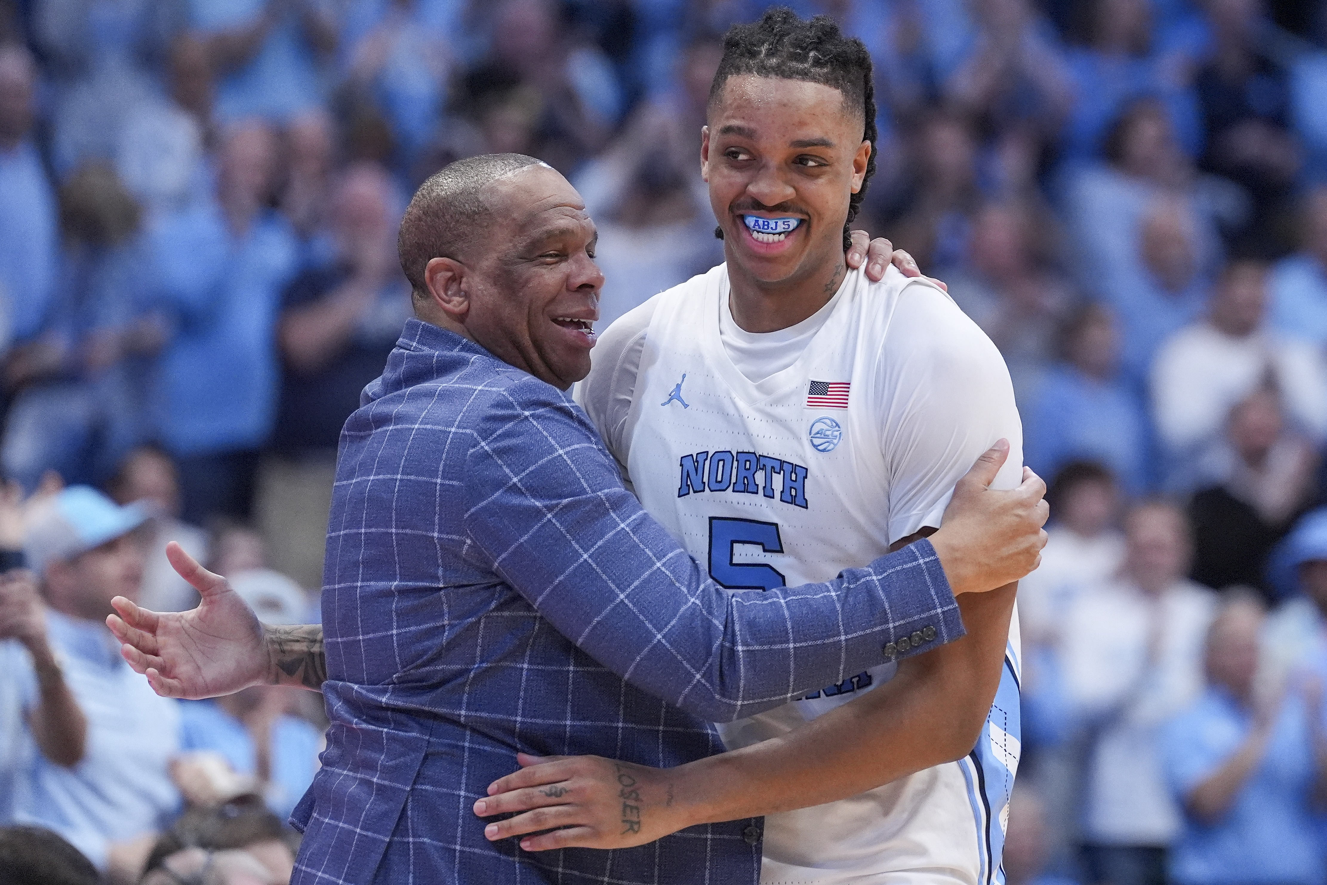 North Carolina Tar Heels head coach Hubert Davis hugs forward Armando Bacot. [IMAGN]