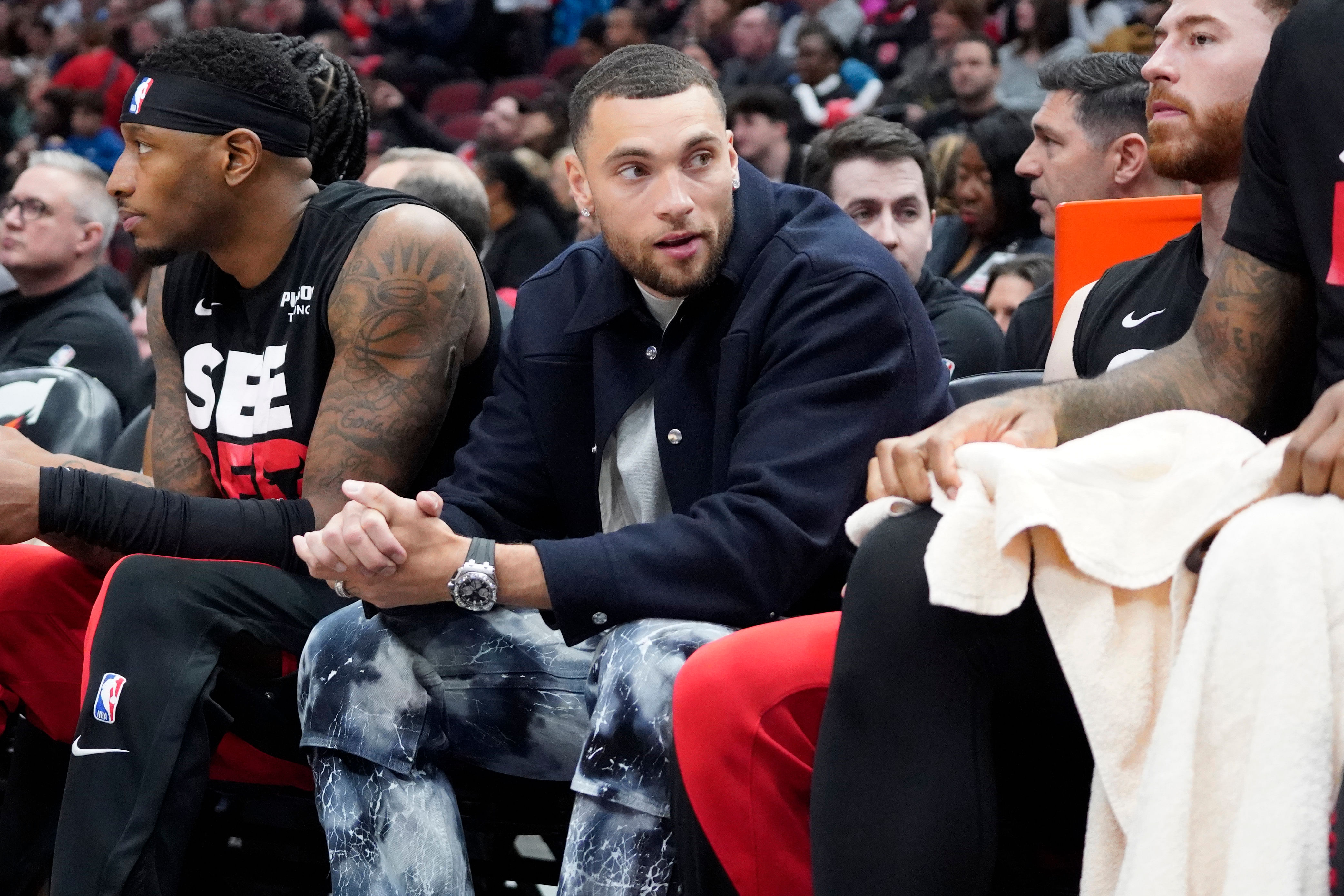 Chicago Bulls guard Zach LaVine sits on the bench in street clothes at United Center. (Photo Credit: Imagn)