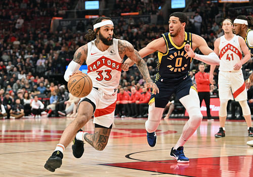 Gary Trent Jr. dribbles the ball past Indiana Pacers guard Tyrese Haliburton (Photo Credit: Imagn)