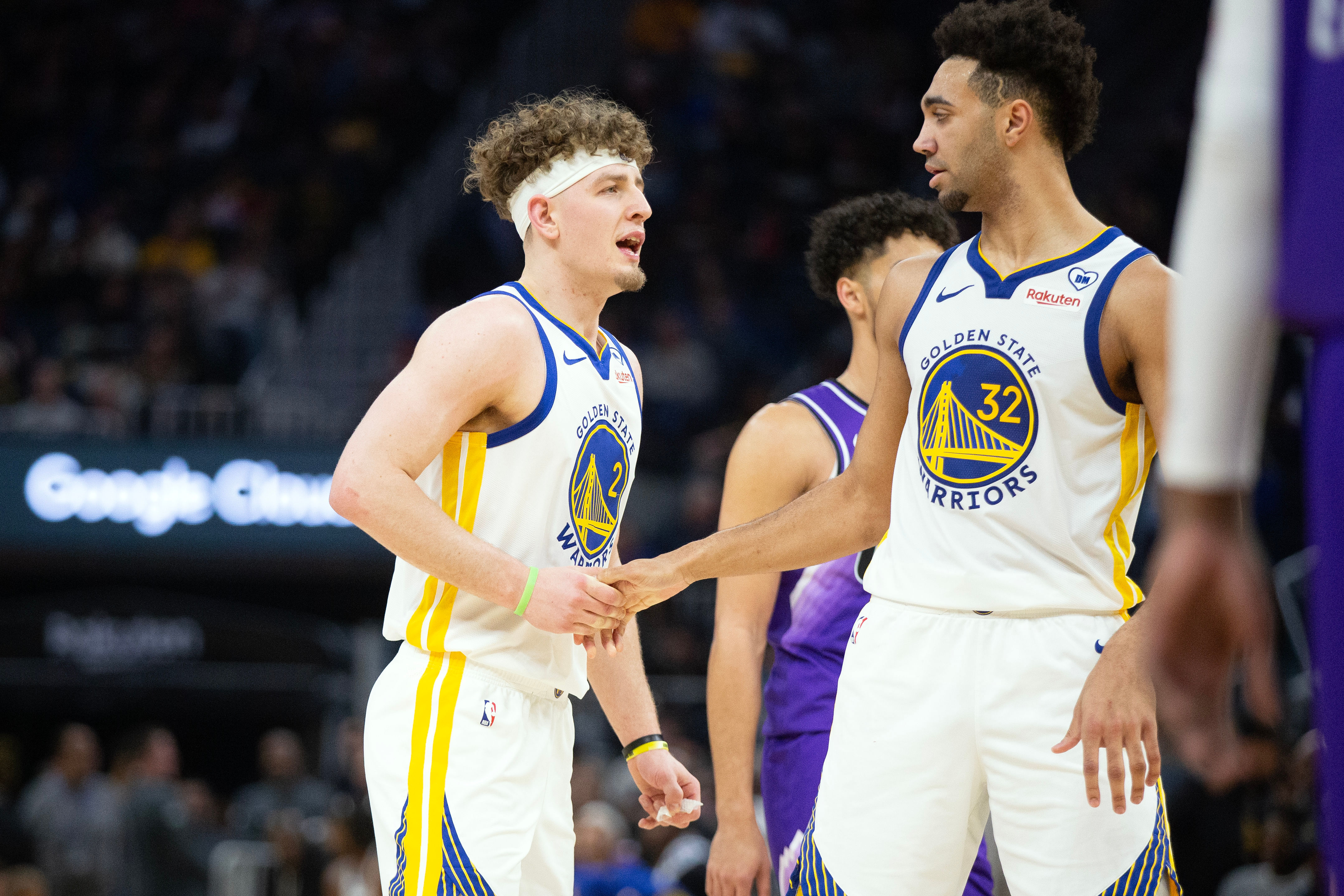 Golden State Warriors guard Brandin Podziemski gets a congratulatory handshake from forward Trayce Jackson-Davis at Chase Center. Photo Credit: D. Ross Cameron-USA TODAY Sports/IMAGN