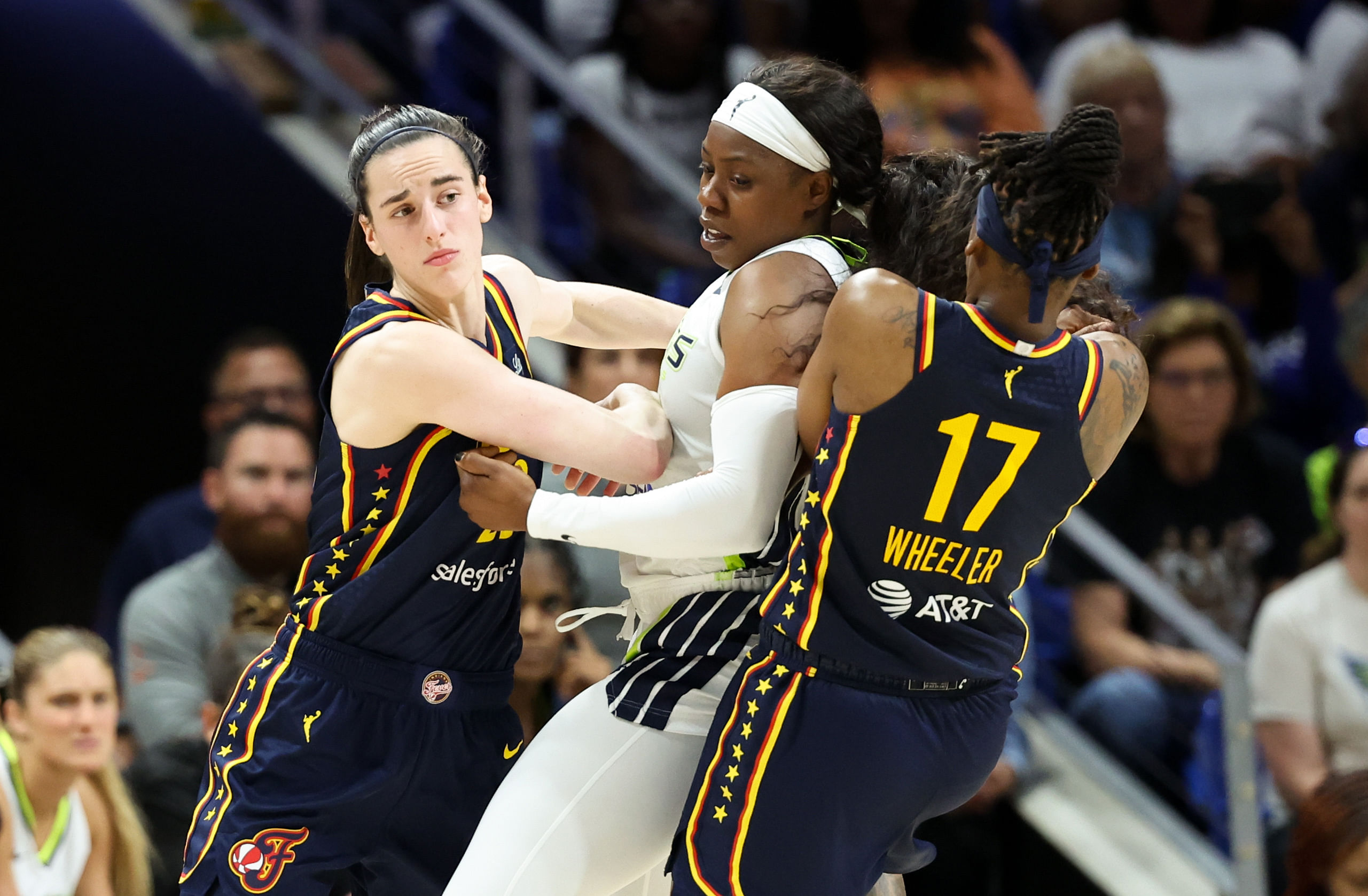 Indiana Fever guard Caitlin Clark looks to break free from Dallas Wings guard Arike Ogunbowale at College Park Center. Photo Credit: Imagn