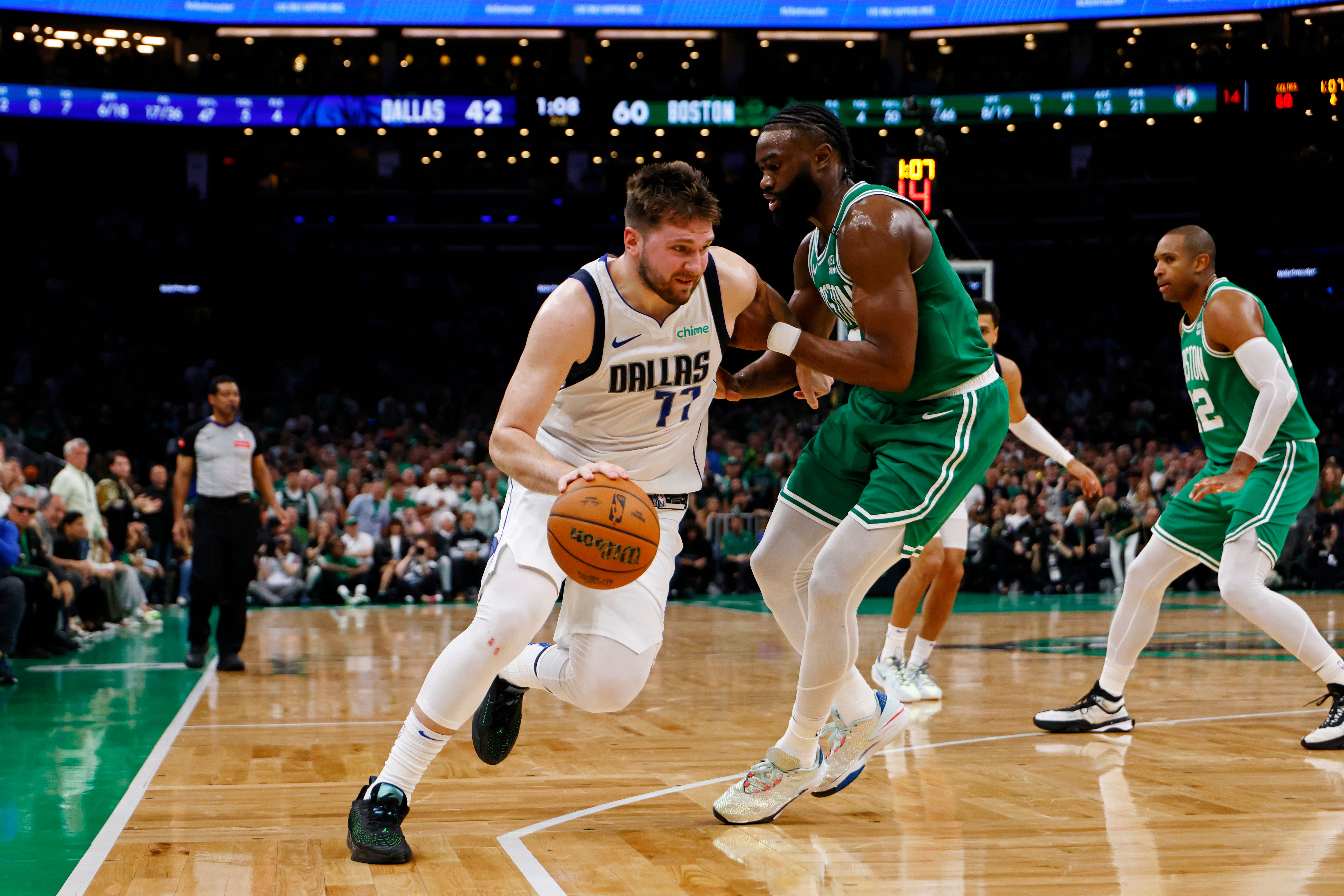 Dallas Mavericks star Luka Doncic driving past Boston Celtics forward Jaylen Brown (IMAGN)