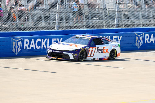 Jun 30, 2024; Nashville, Tennessee, USA; NASCAR Cup Series driver Denny Hamlin (11) races during the Ally 400 at Nashville Superspeedway. Mandatory Credit: Steve Roberts-USA TODAY Sports