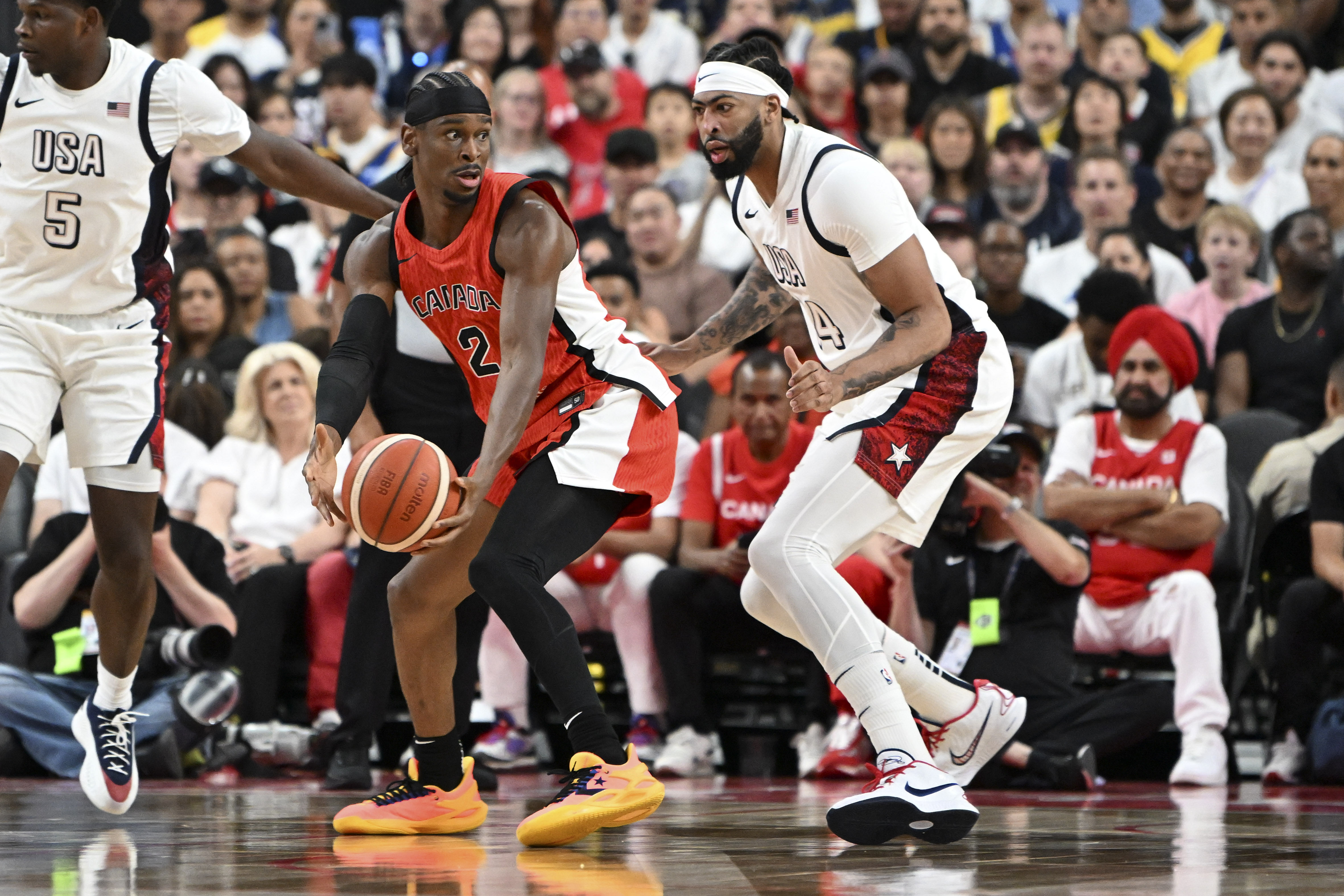 Canada guard Shai Gilgeous-Alexander looks to make a pass against USA. Photo Credit: Imagn