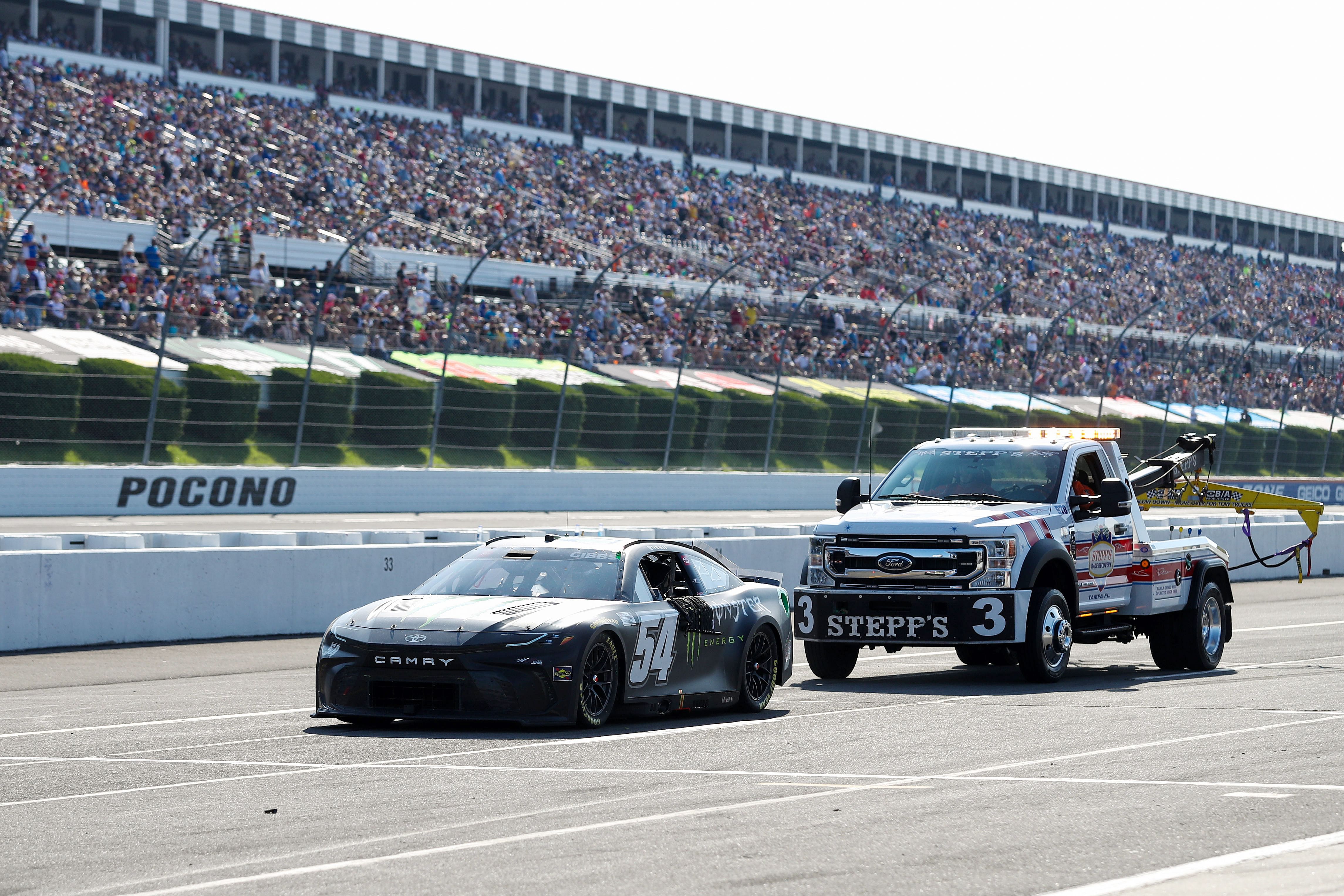 Long Pond, Pennsylvania, USA; NASCAR Cup Series driver Ty Gibbs (54) is pushed on pit road after suffering an engine failure during The Great American Getaway 400 at Pocono Raceway. Mandatory Credit: Matthew O&#039;Haren-USA TODAY Sports