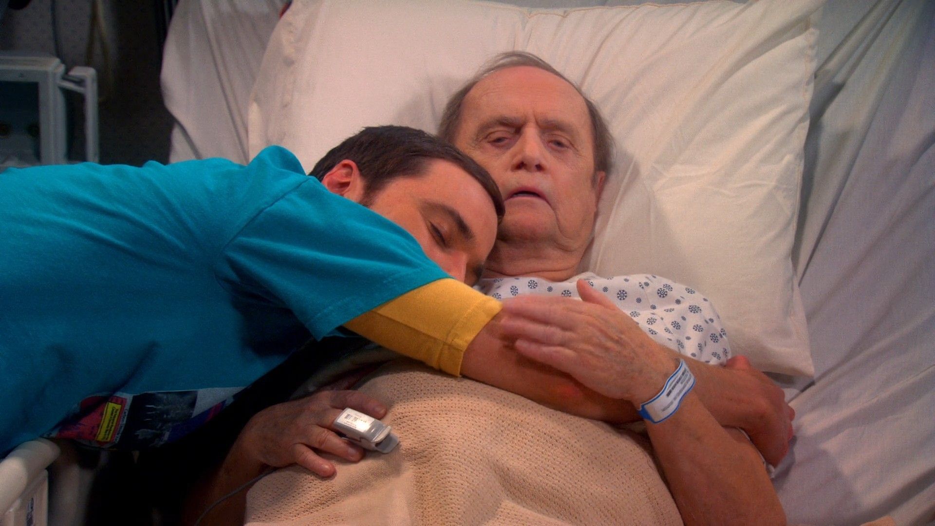 Bob Newhart as Professor Proton, hugging Jim Parsons as Sheldon Cooper on The Big Bang Theory (Image via Netflix)