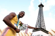 Noah Lyles poses with a miniature Eiffel Tower at Hayward Field in Eugene, Oregon.