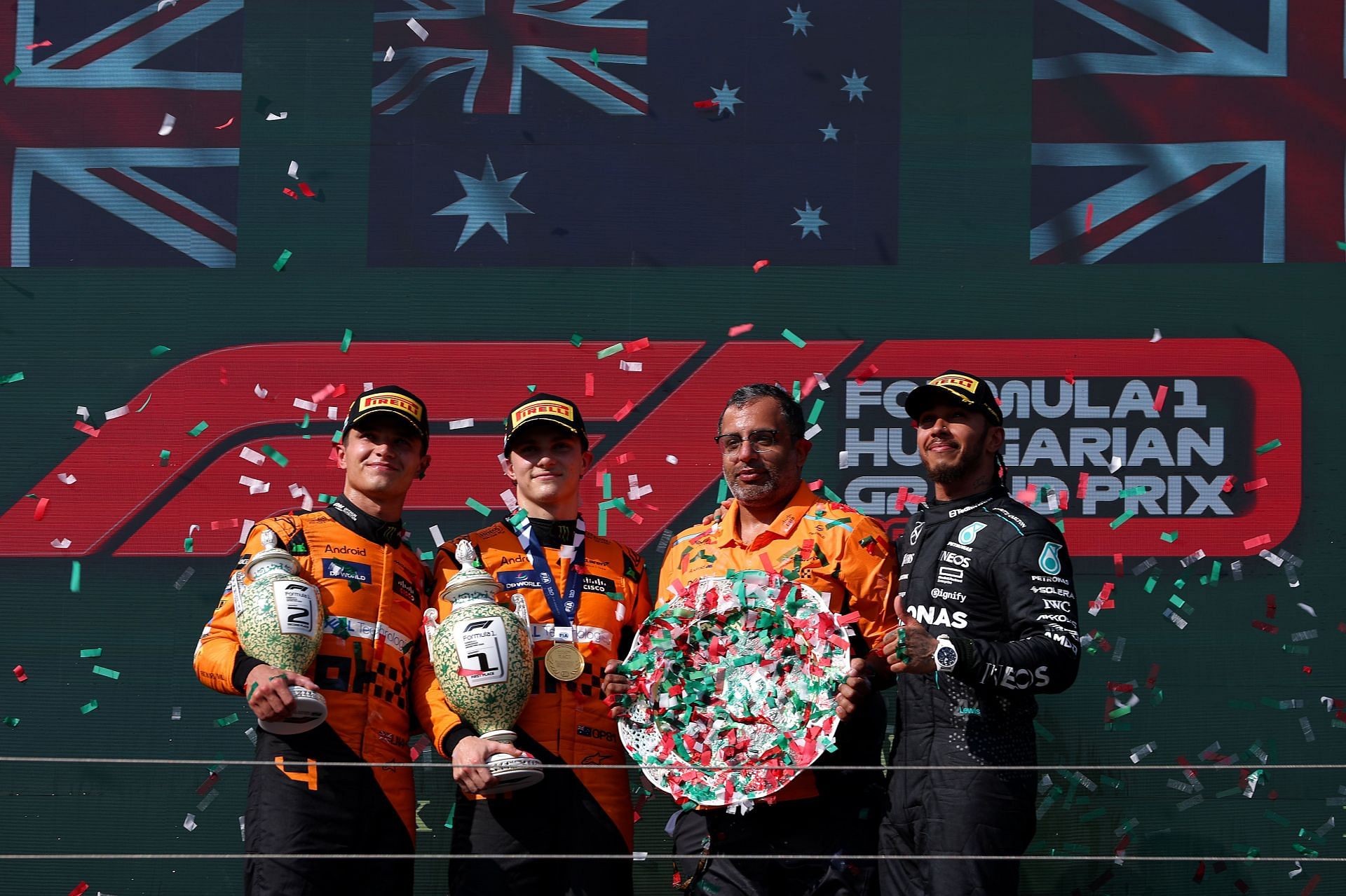 Oscar Piastri, Lando Norris, Lewis Hamilton, and Randy Singh, Strategy and Sporting Director of McLaren, celebrate on the podium during the F1 Grand Prix of Hungary at Hungaroring on July 21, 2024, in Budapest, Hungary. (Photo by Dean Mouhtaropoulos/Getty Images)