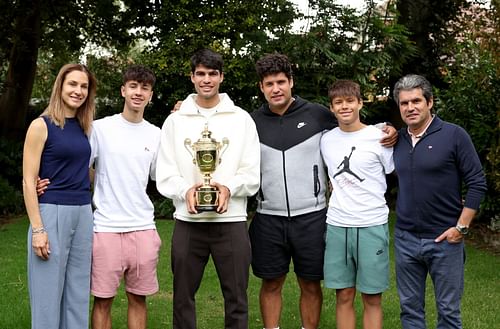 Alcaraz with his parents and brothers at the official Champion's Photocall - Wimbledon 2024 (Image Source: Getty)