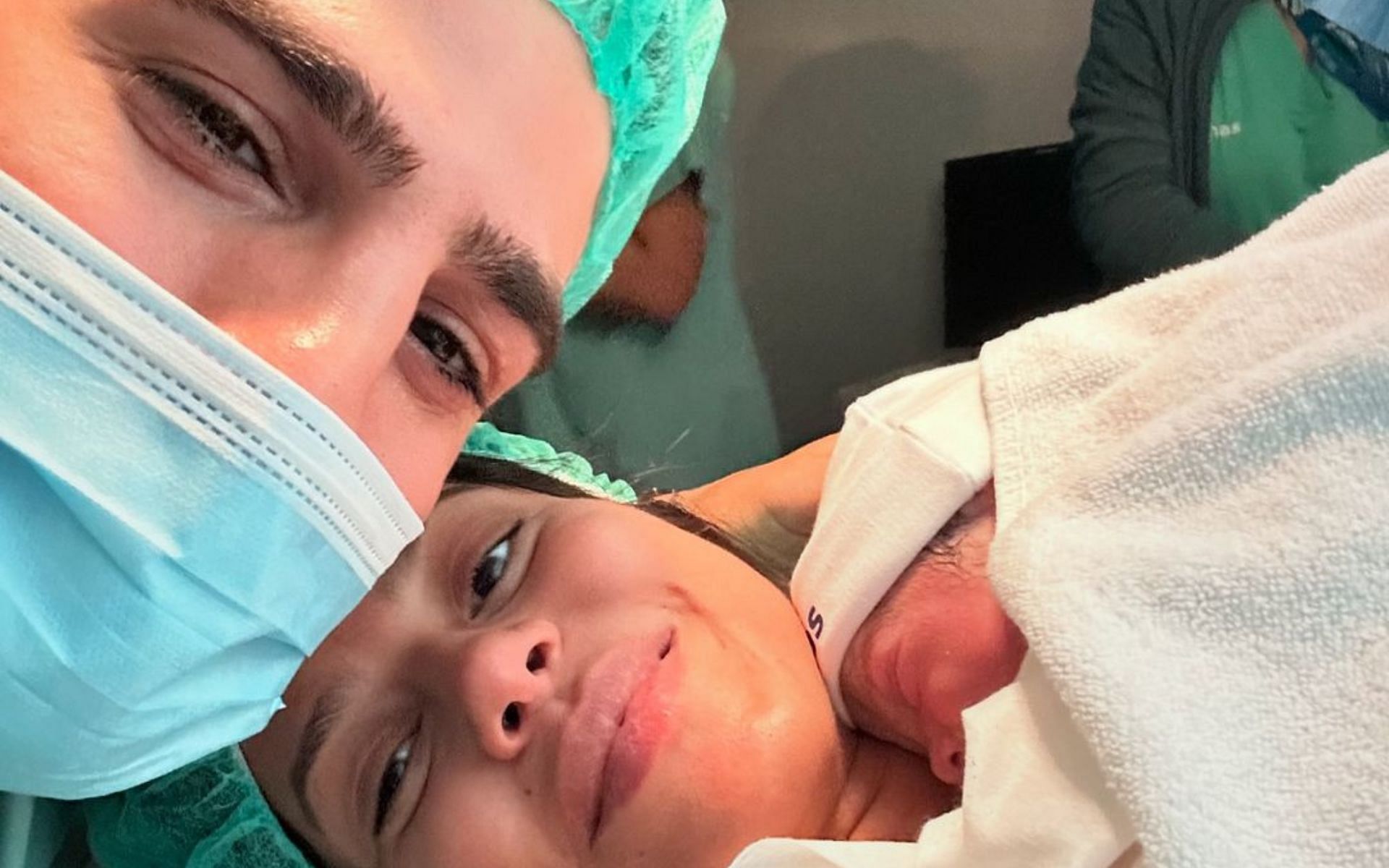 Ilia Topuria with his partner and newborn baby