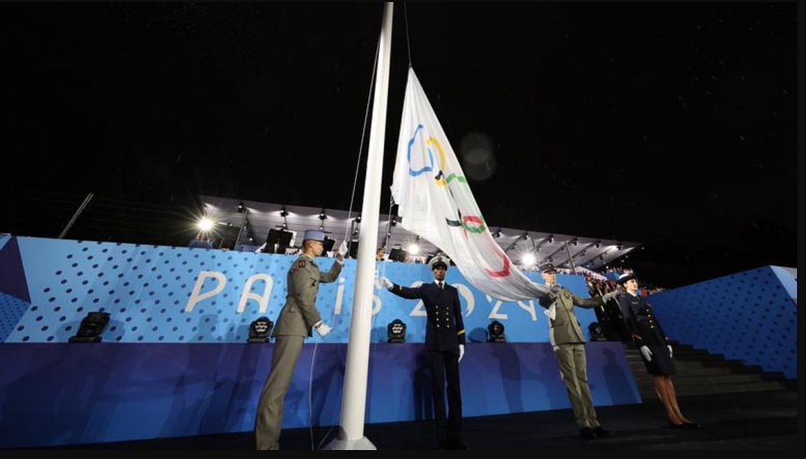 The Olympic flag being hoisted at Paris Olympics 2024 [Image Source: Getty]