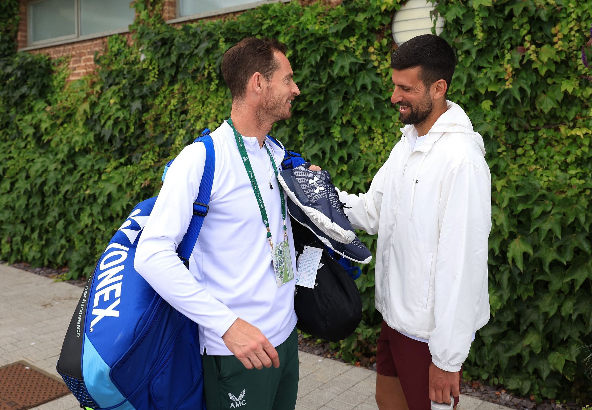 Andy Murray (L) and Novak Djokovic pictured at Wimbledon 2024