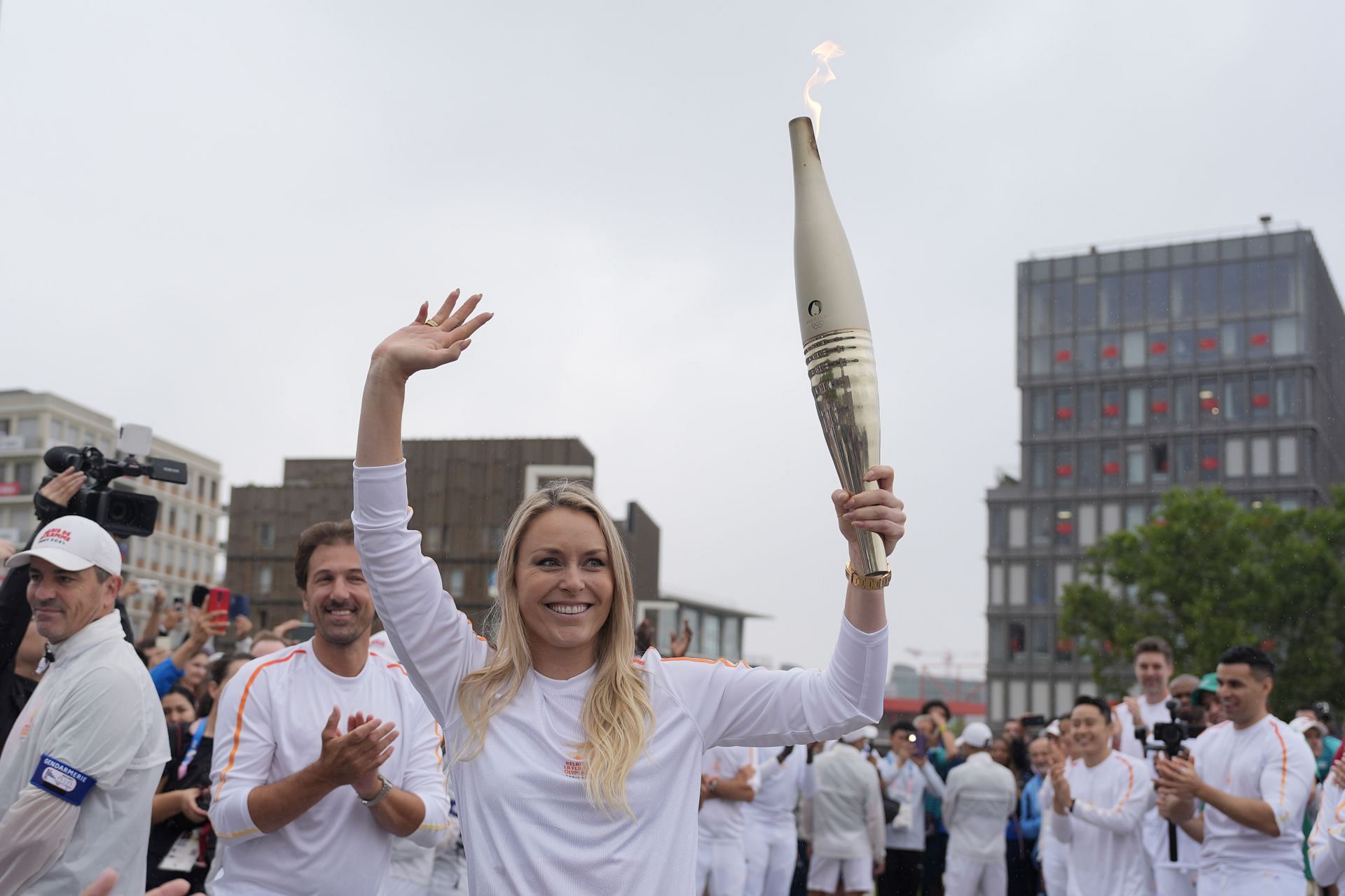 Former US skier Lindsey Vonn carries the Olympic torch in the Olympic village during the torch relay ahead of the Summer Olympic Games Paris 2024. (Photo by David Goldman - Pool/Getty Images)