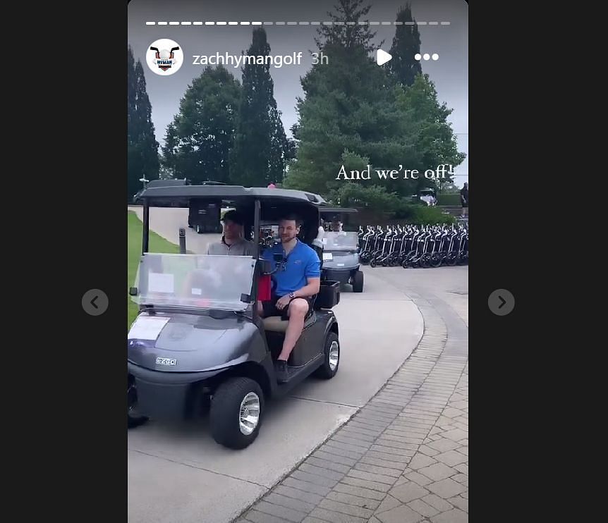 Hyman and McDavid riding Golf cart at the event.