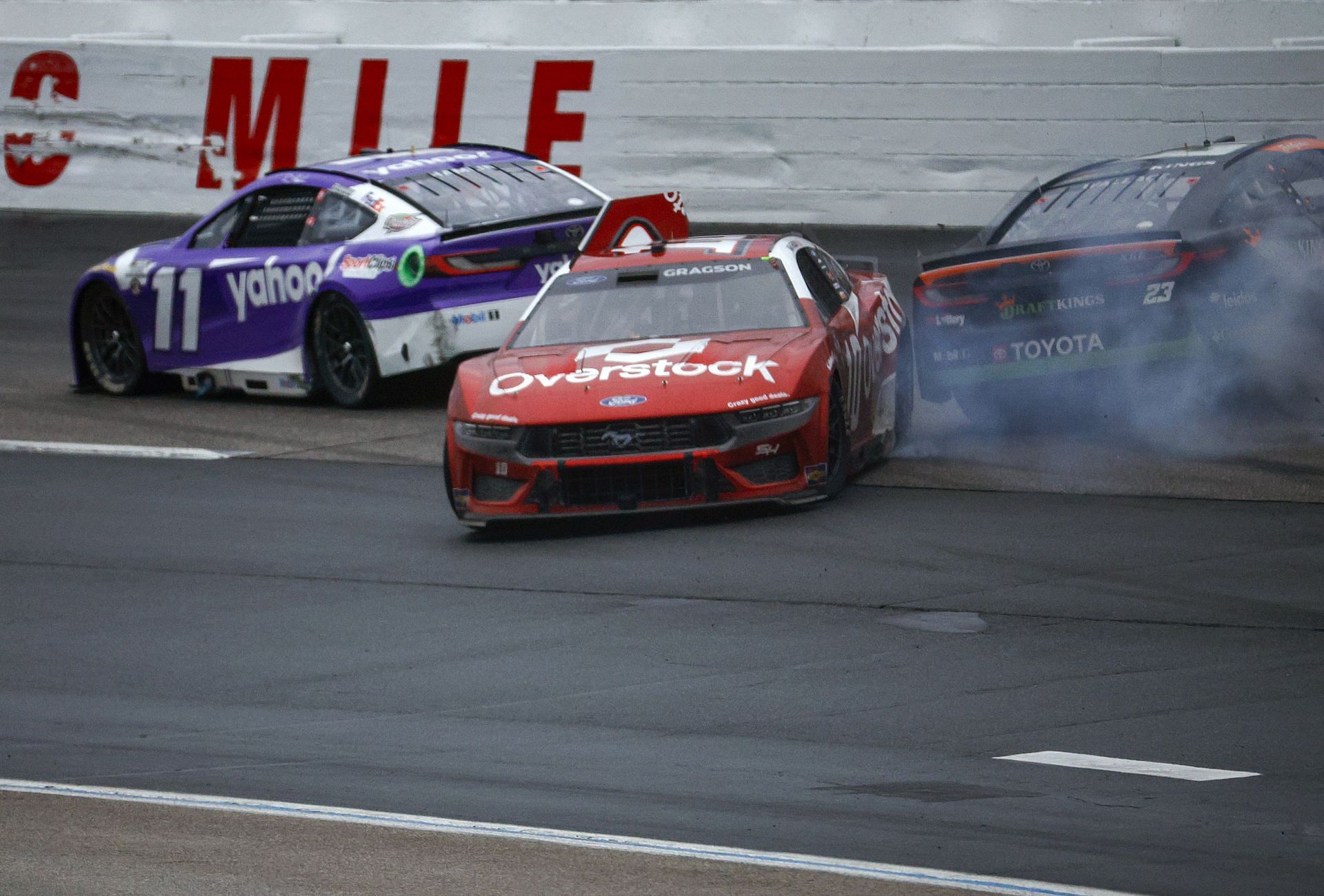 LOUDON, NEW HAMPSHIRE - JUNE 23: Noah Gragson, driver of the #10 Overstock.com Ford, and Bubba Wallace, driver of the #23 DraftKings Toyota, spin after an on-track incident during the NASCAR Cup Series USA Today 301 at New Hampshire Motor Speedway on June 23, 2024 in Loudon, New Hampshire. (Photo by Sean Gardner/Getty Images)