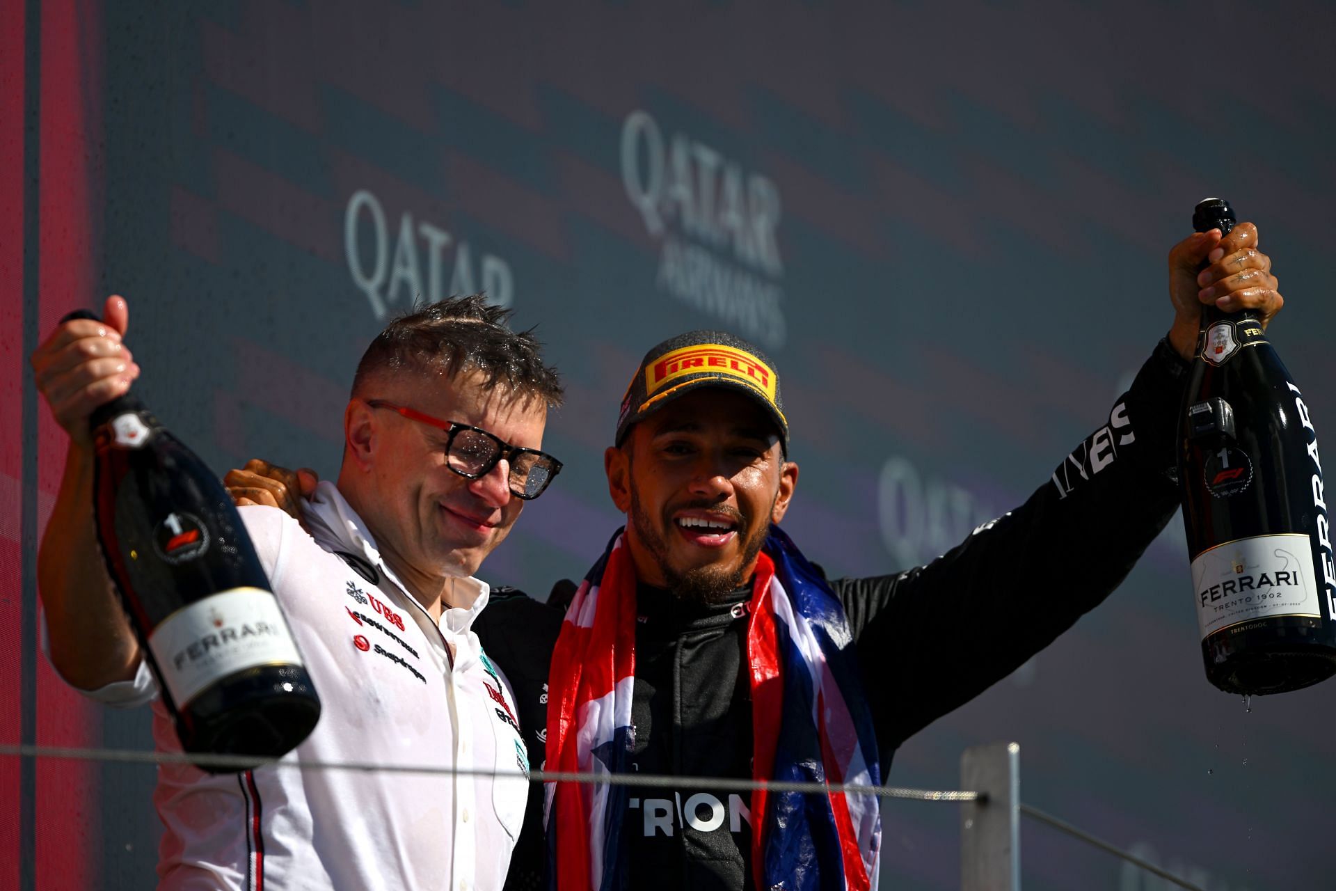 NORTHAMPTON, ENGLAND - JULY 07: Race winner Lewis Hamilton of Great Britain and Mercedes celebrates with race engineer Peter Bonnington on the podium during the F1 Grand Prix of Great Britain at Silverstone Circuit on July 07, 2024 in Northampton, England. (Photo by Rudy Carezzevoli/Getty Images)