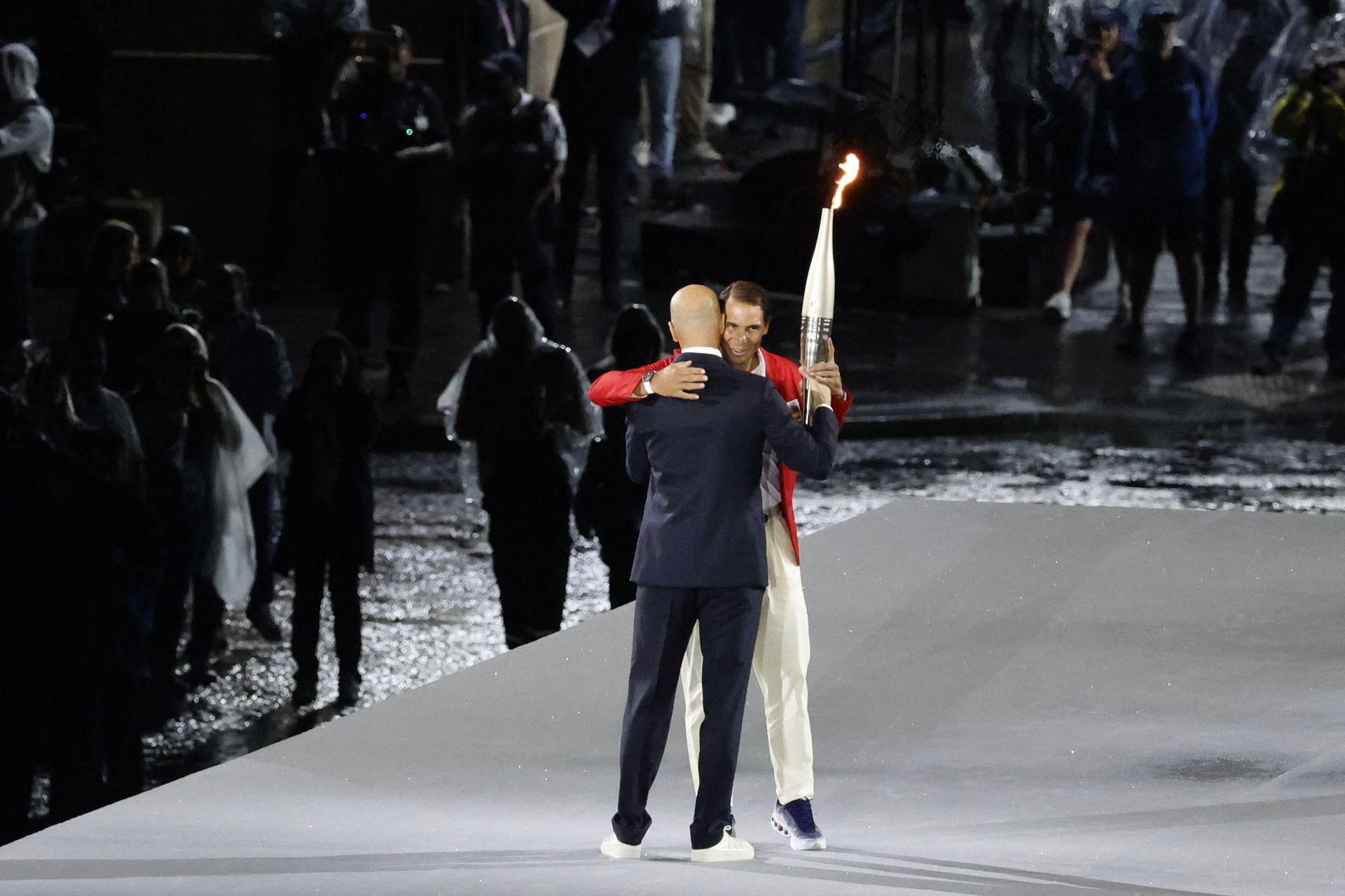 Zinedine Zidane handing over the Olympic flame to Rafael Nadal at the opening ceremony [Image Source: Getty]