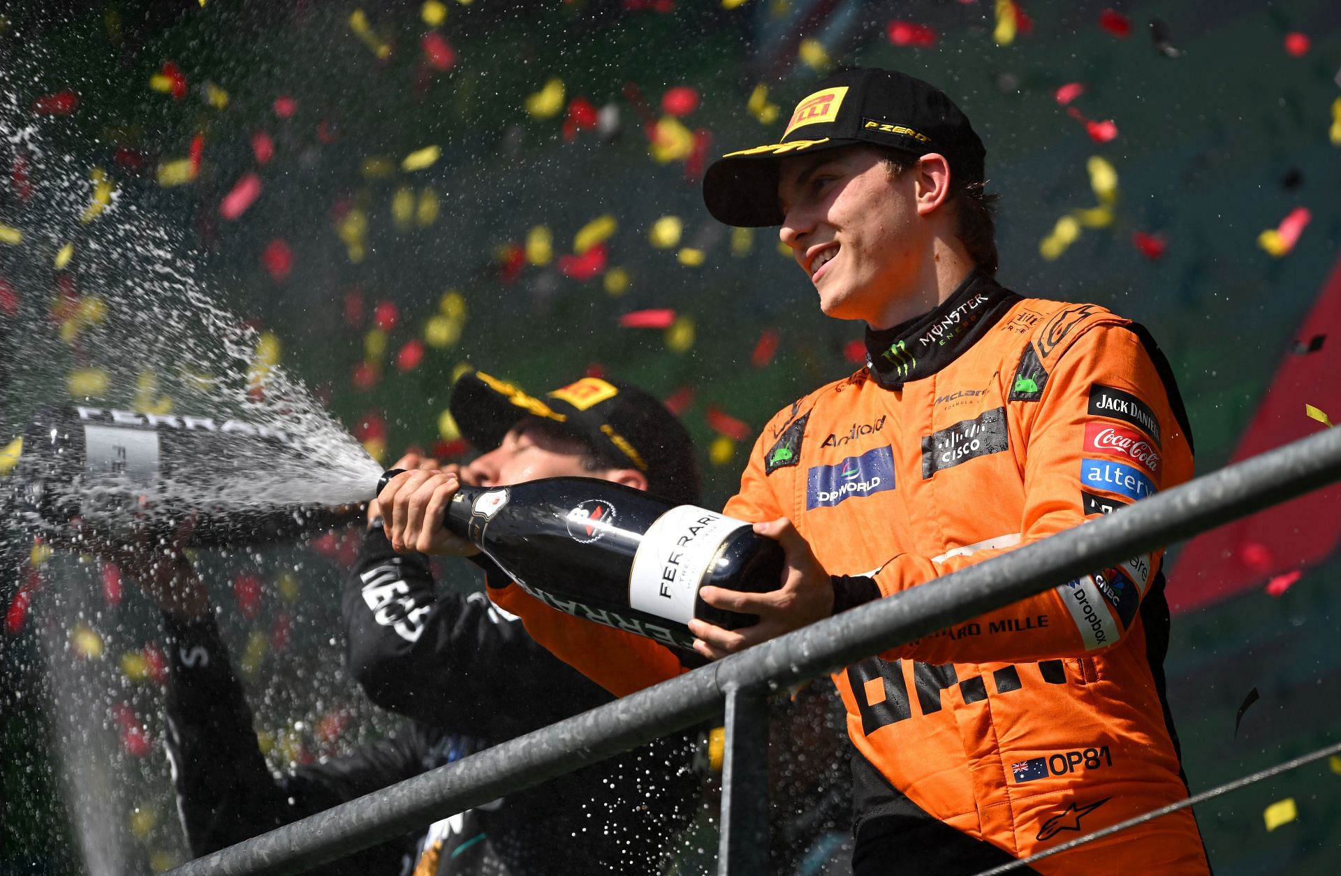 Oscar Piastri celebrates on the podium at the Belgian GP. (Image via Getty)