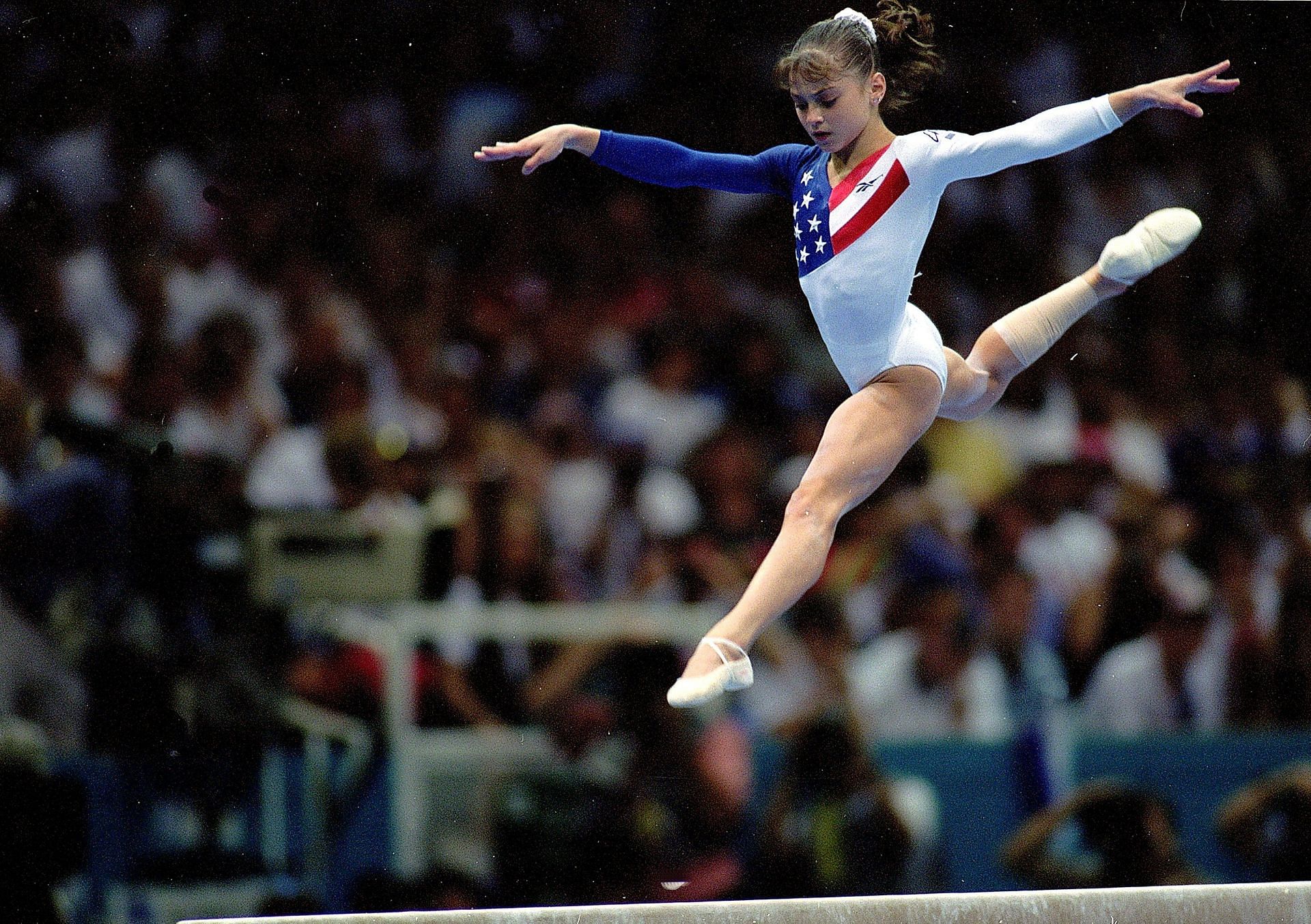 Dominique Moceanu of the USA leaps during the Women&#039;s Beam event at the Georgia Dome in the 1996 Olympic Games in Atlanta, Georgia.