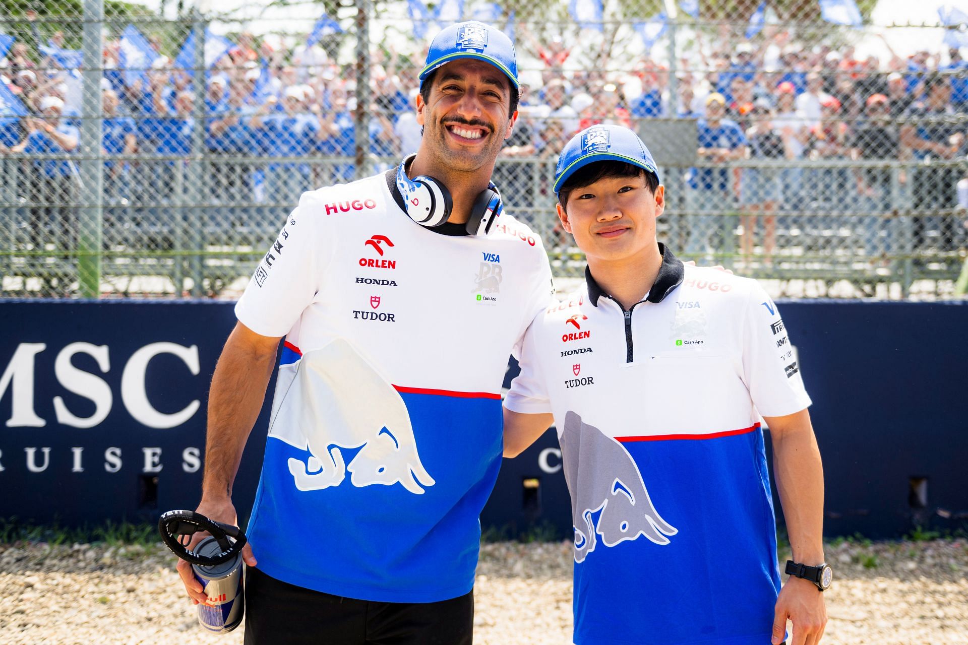 Daniel Ricciardo and Yuki Tsunoda of Visa Cash App RB pose for a photo with the Visa Cash App RB grandstand on the drivers parade prior to the F1 Grand Prix of Emilia-Romagna at Autodromo Enzo e Dino Ferrari Circuit on May 19, 2024 in Imola, Italy. (Photo by Rudy Carezzevoli/Getty Images)