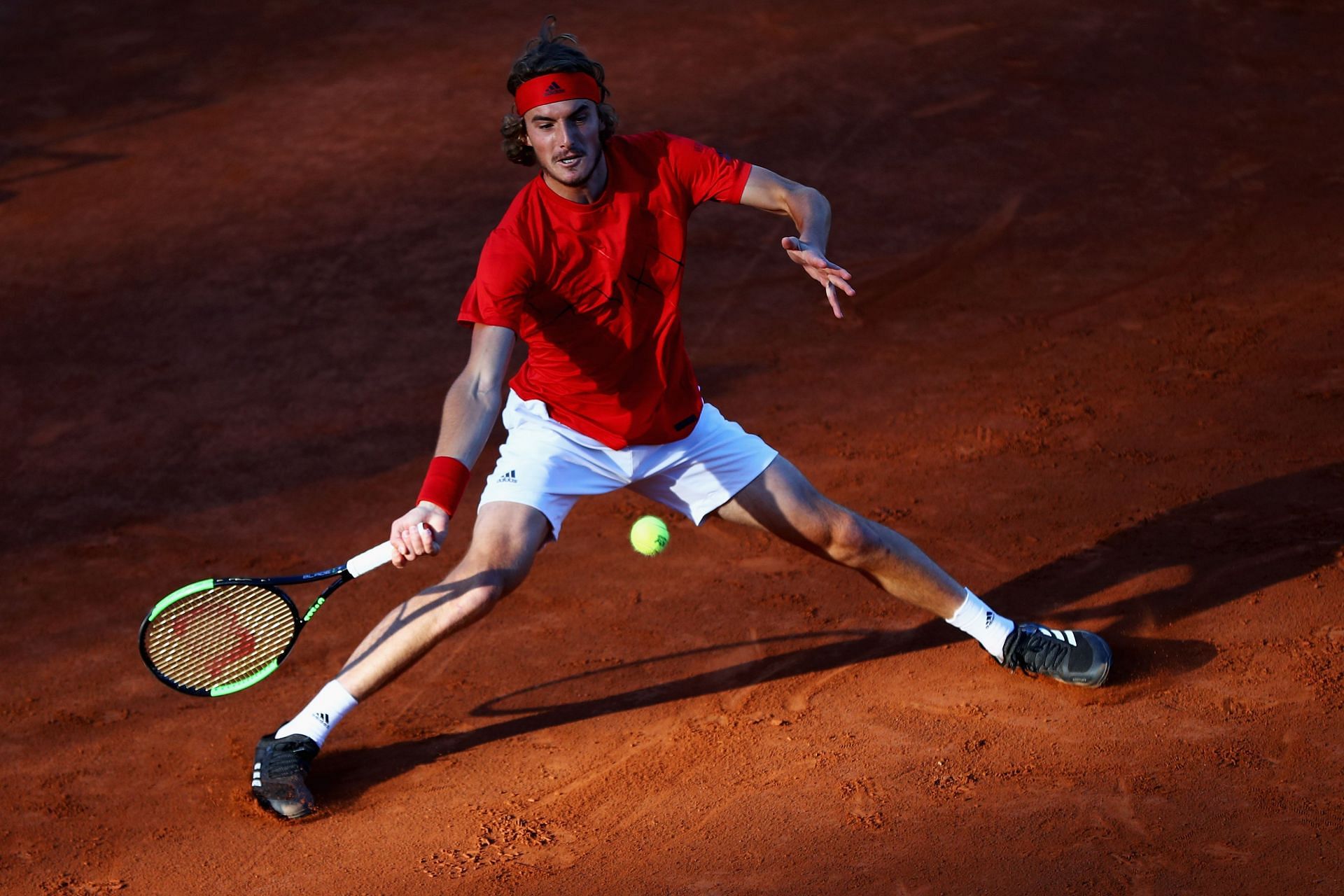 Stefanos Tsitsipas hitting a sliding forehand on clay (Getty Images)