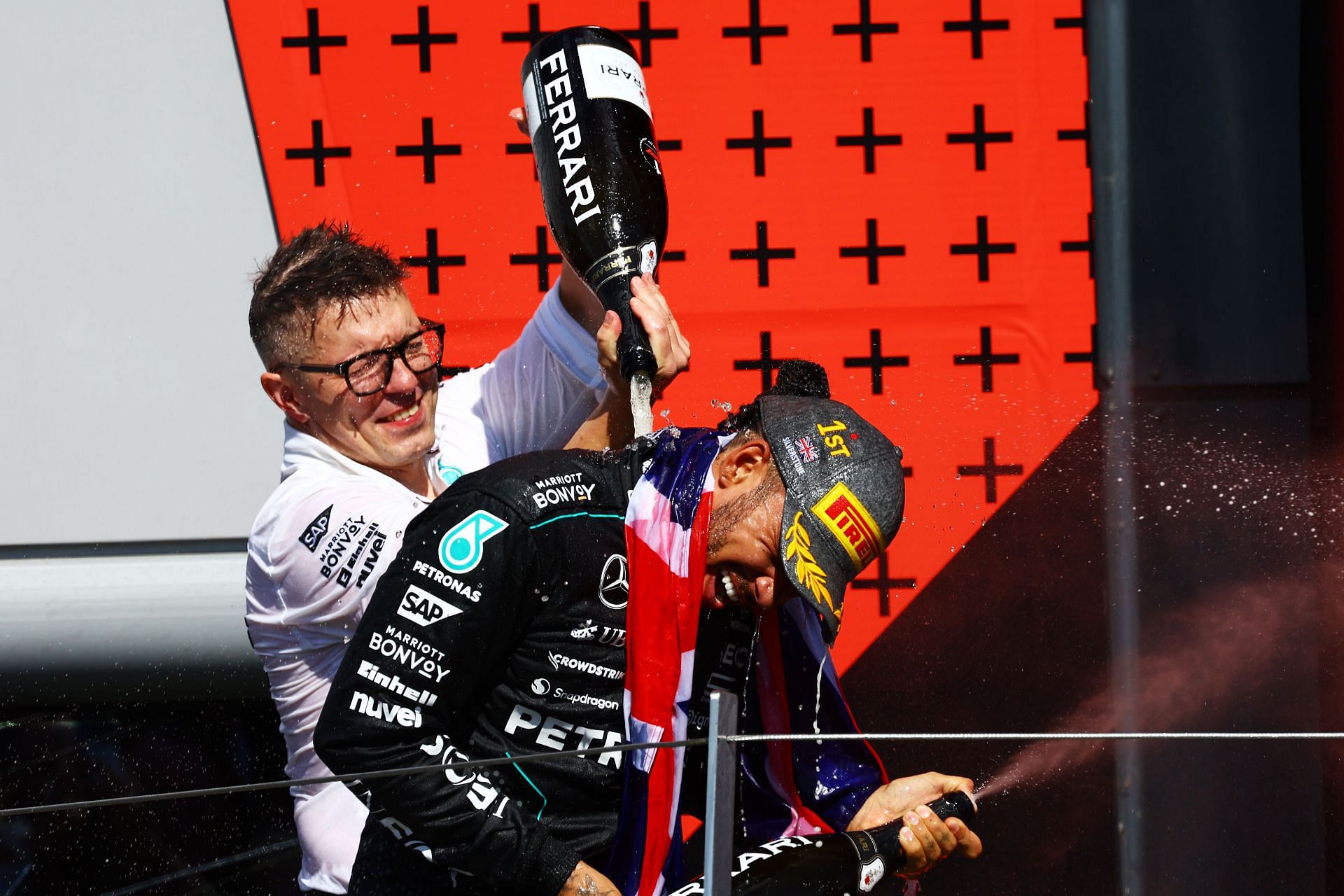 Race winner Lewis Hamilton of Great Britain and Mercedes celebrates with race engineer Peter Bonnington on the podium during the F1 Grand Prix of Great Britain at Silverstone Circuit on July 07, 2024 in Northampton, England. (Photo by Mark Thompson/Getty Images)