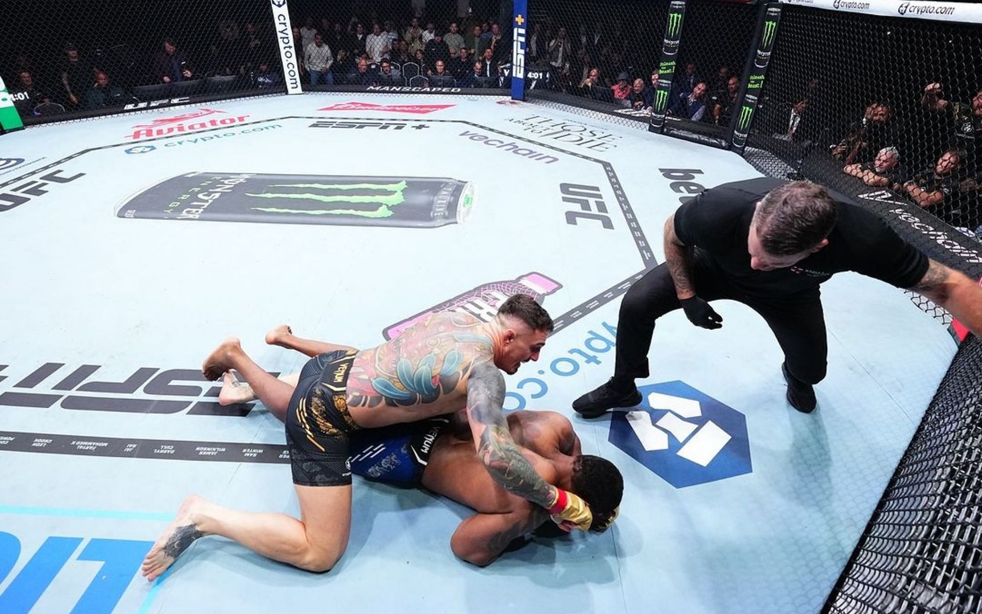 Tom Aspinall (left) reacts to early stoppage claims against Curtis Blaydes (center). [Image courtesy: @ufcindia on Instagram] 