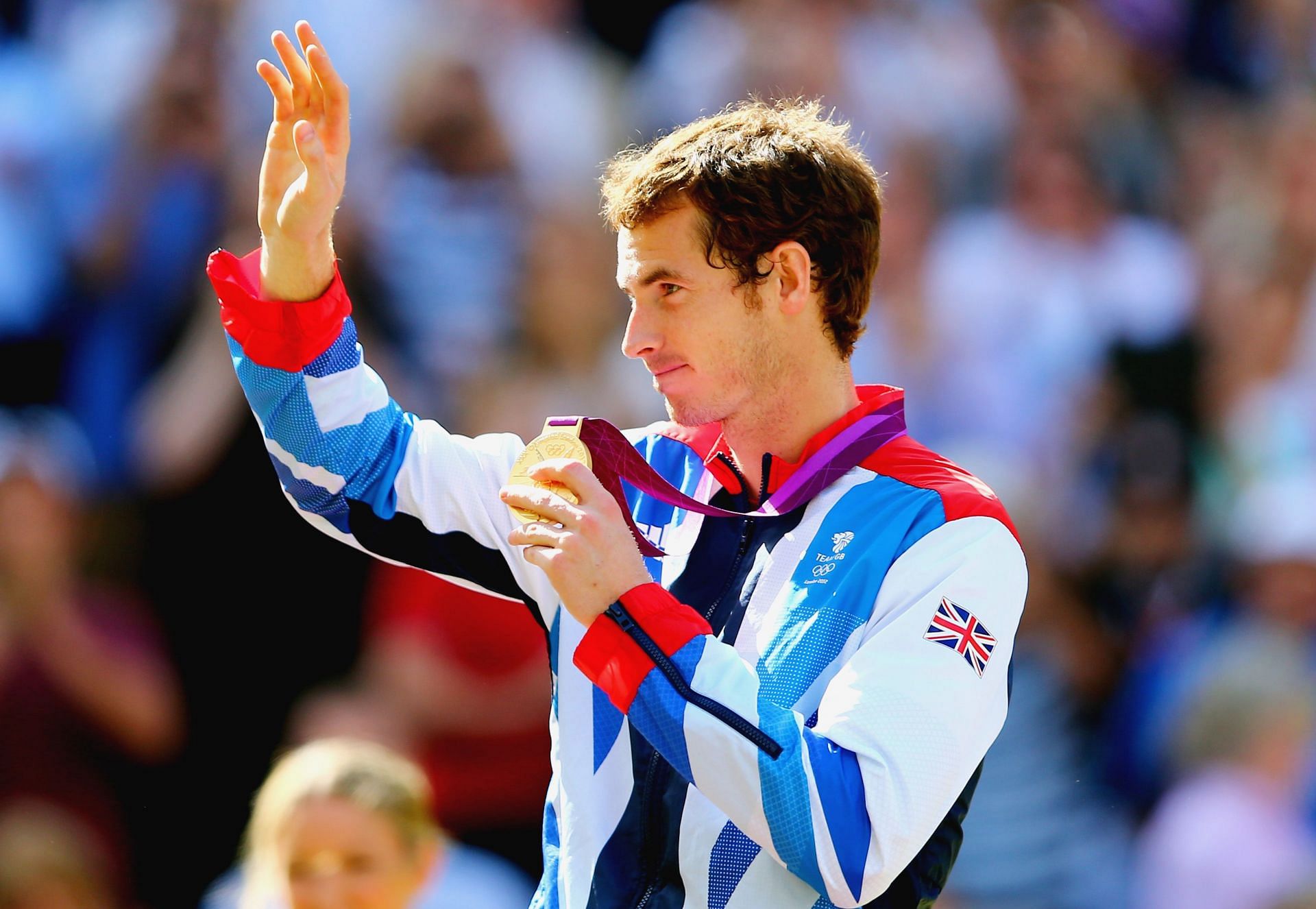 Andy Murray waves to the crowd from the podium at London Olympics