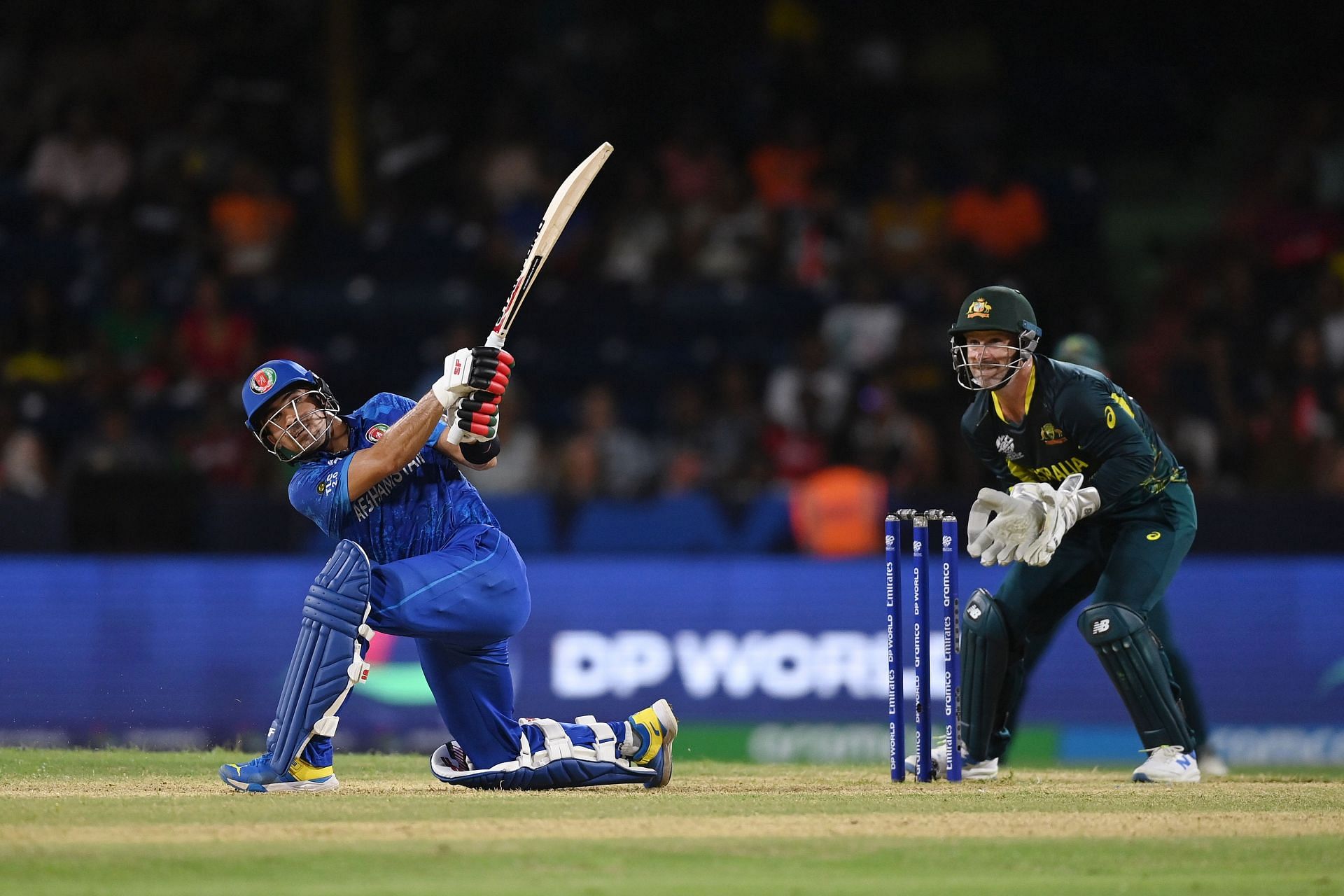 Rahmanullah Gurbaz of Afghanistan hits a six as Matthew Wade of Australia looks on during the ICC Men's T20 Cricket World Cup West Indies & USA 2024 Super Eight match between Afghanistan and Australia at Arnos Vale Ground on June 22, 2024 in St Vincent, Saint Vincent and The Grenadines. (Photo by Gareth Copley/Getty Images)