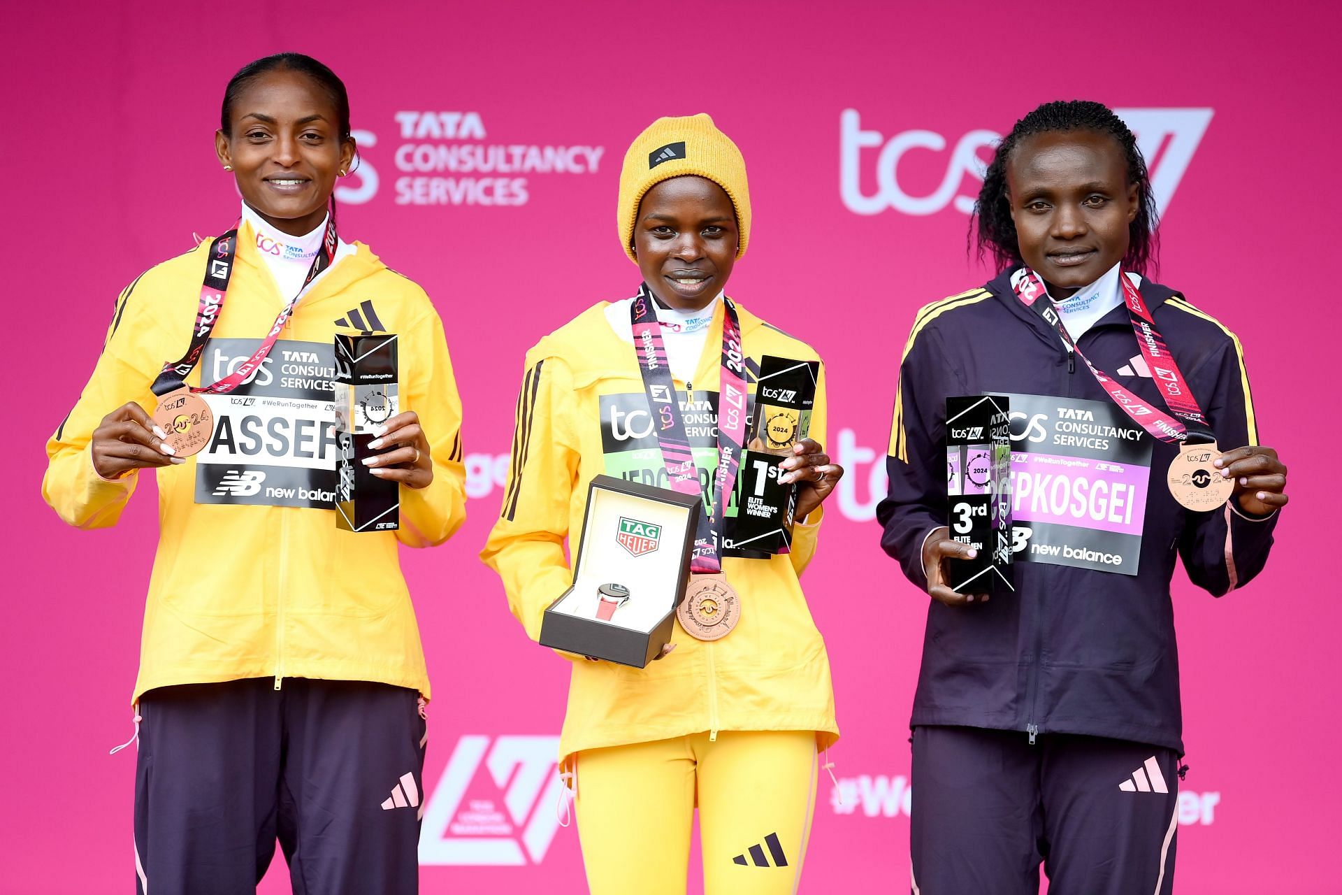 Tigst Assefa (left) poses for a group picture after winning a medal at the 2024 TCS London Marathon (Image Credits: Getty Images)