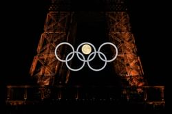 [In pictures] The moon aligns itself in between the Olympic Rings at the Eiffel Tower