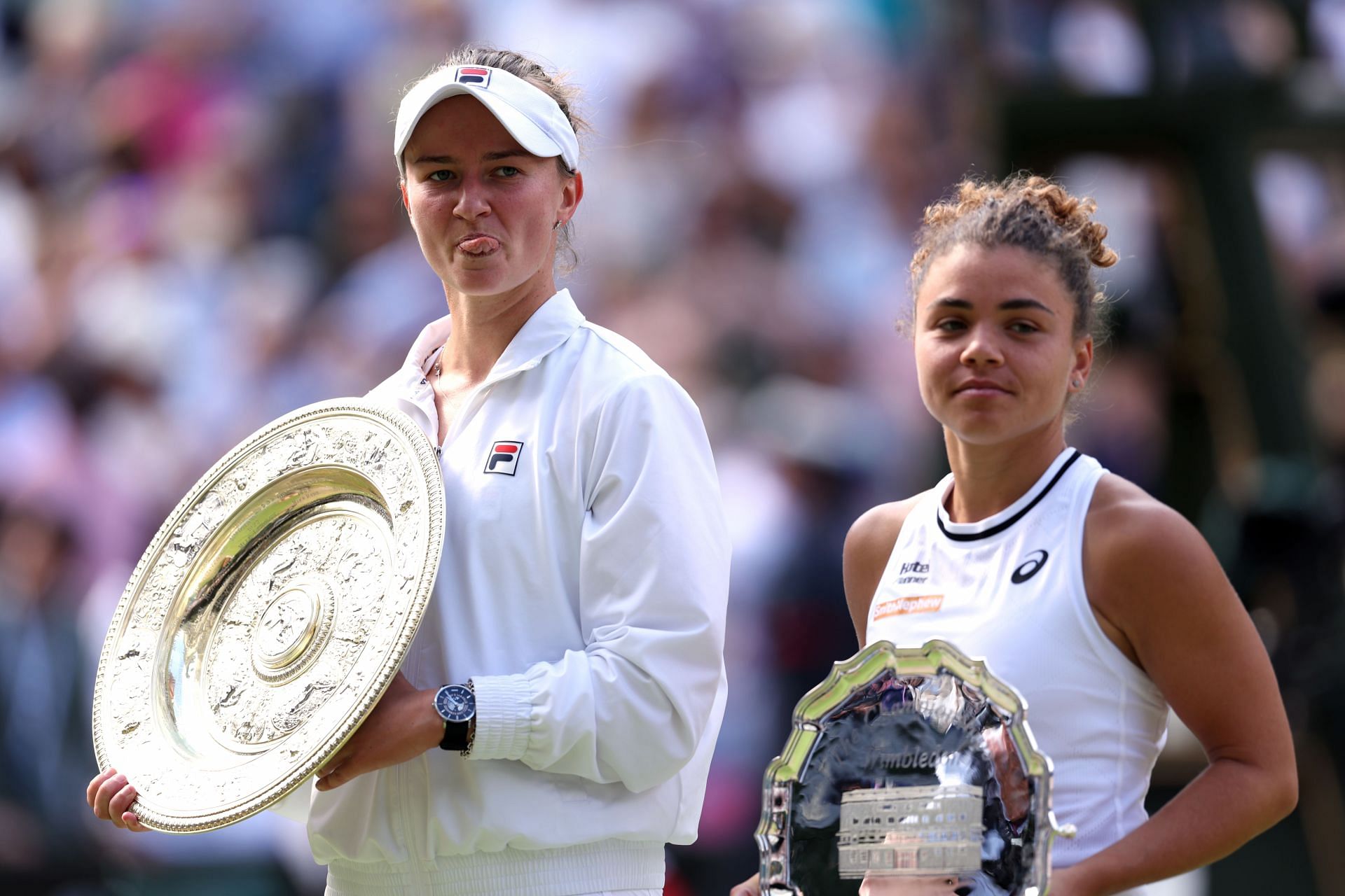 Barbora Krejcikova (L) and Jasmine Paolini (R) during the trophy presentation ceremony at the 2024 Wimbledon Championships