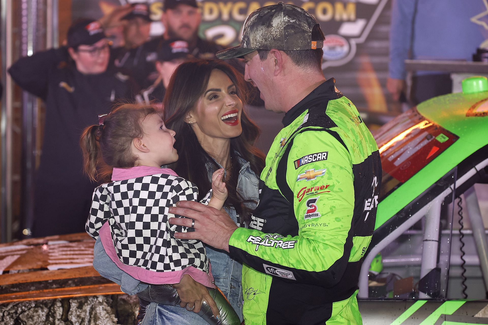 Kyle Busch, driver of the #7 Realtree Chevrolet, celebrates with his wife, Samantha Busch, and daughter, Lennix Busch victory lane after winning the NASCAR Craftsman Truck Series SpeedyCash.com 250 at Texas Motor Speedway on April 12, 2024 in Fort Worth, Texas. (Photo by Chris Graythen/Getty Images)